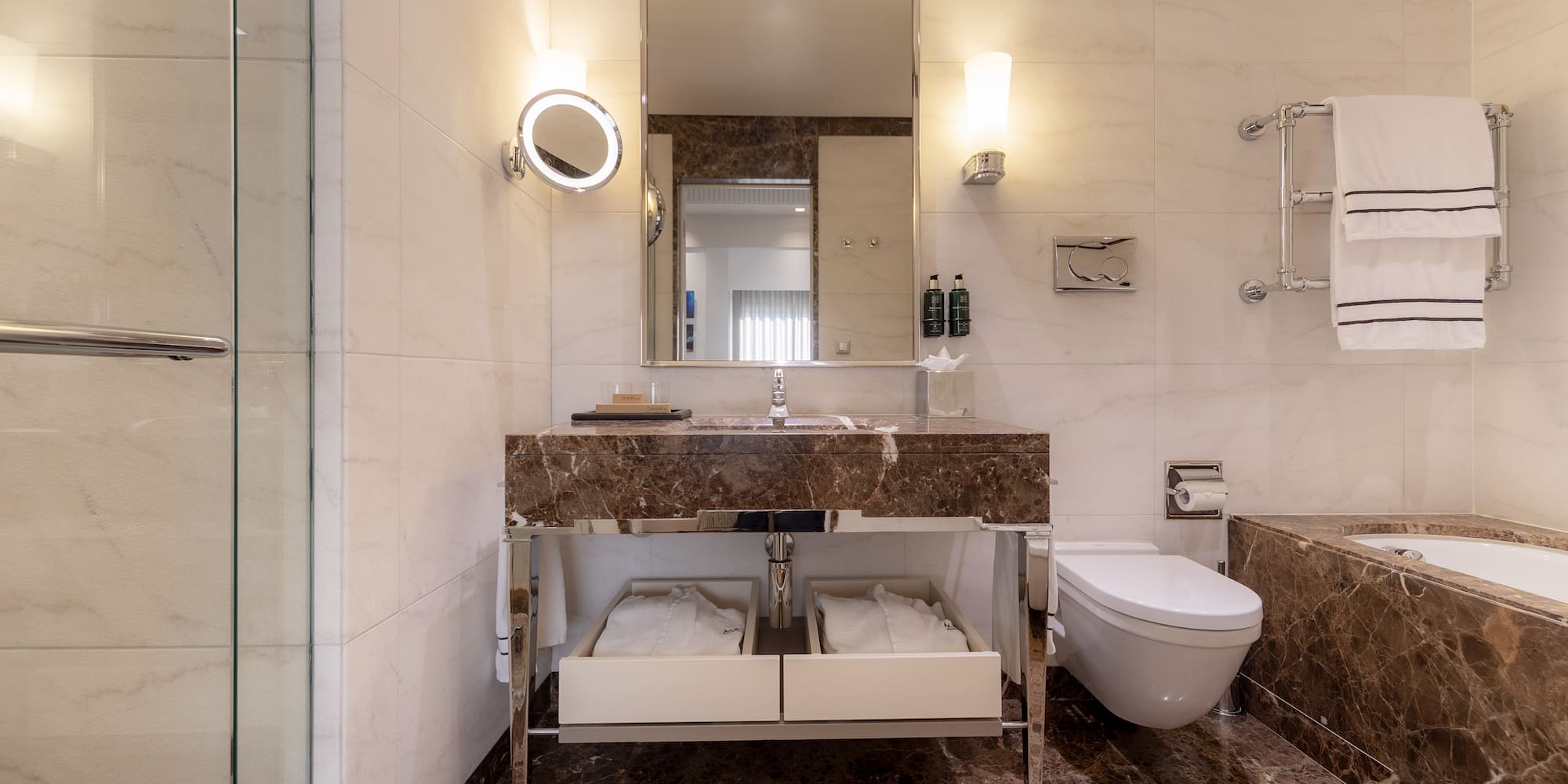 a bathroom with marble countertop and a toilet