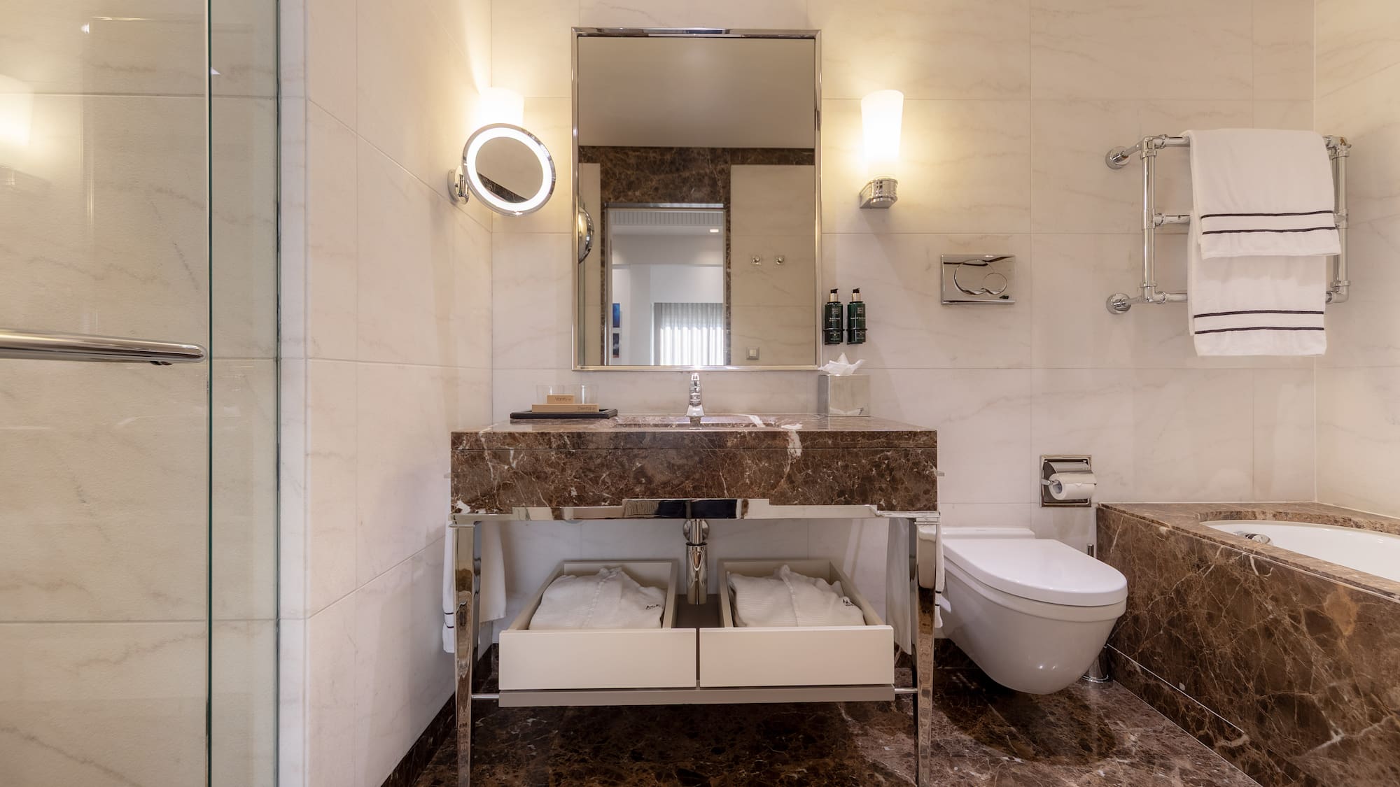 a bathroom with marble countertop and a toilet