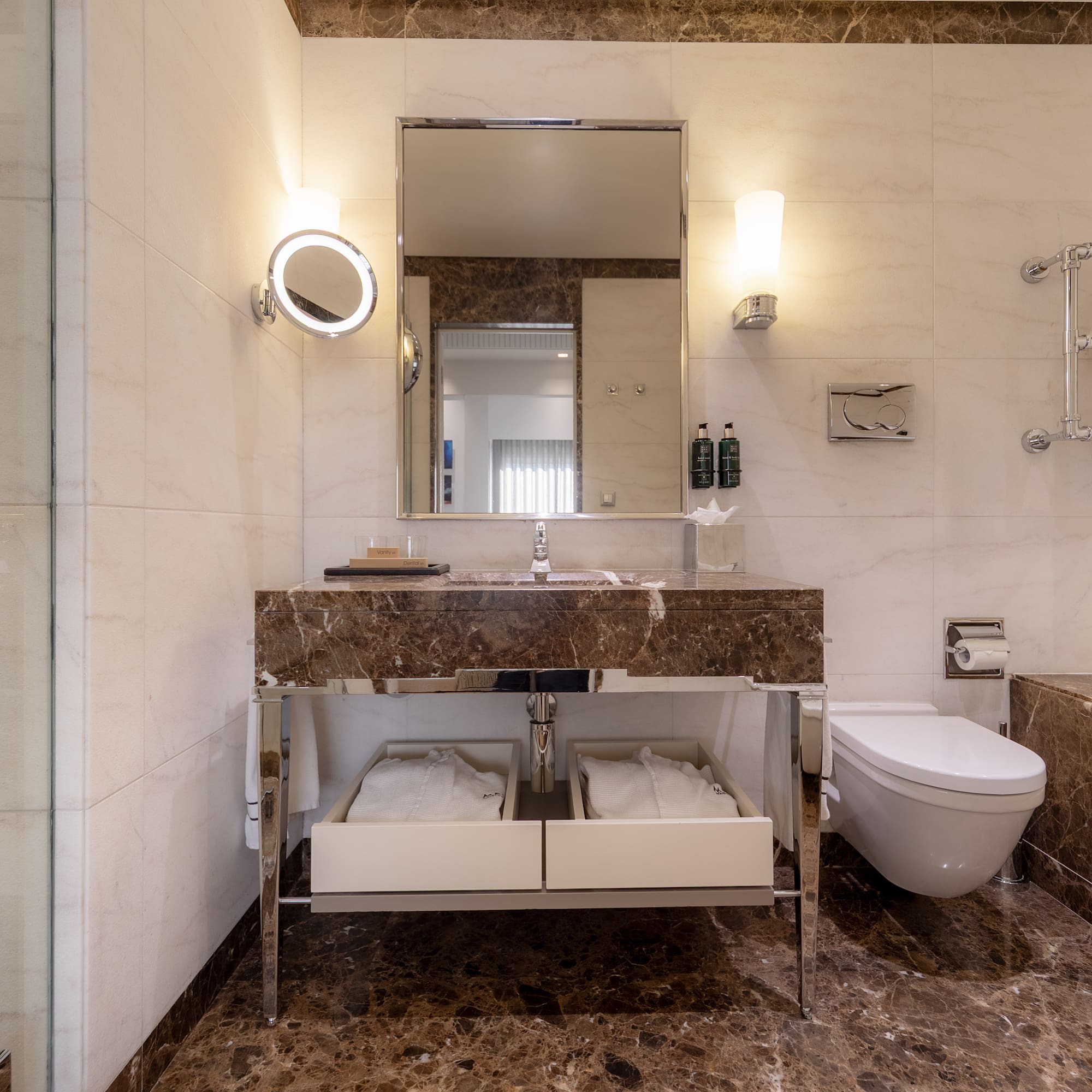 a bathroom with marble countertop and a toilet