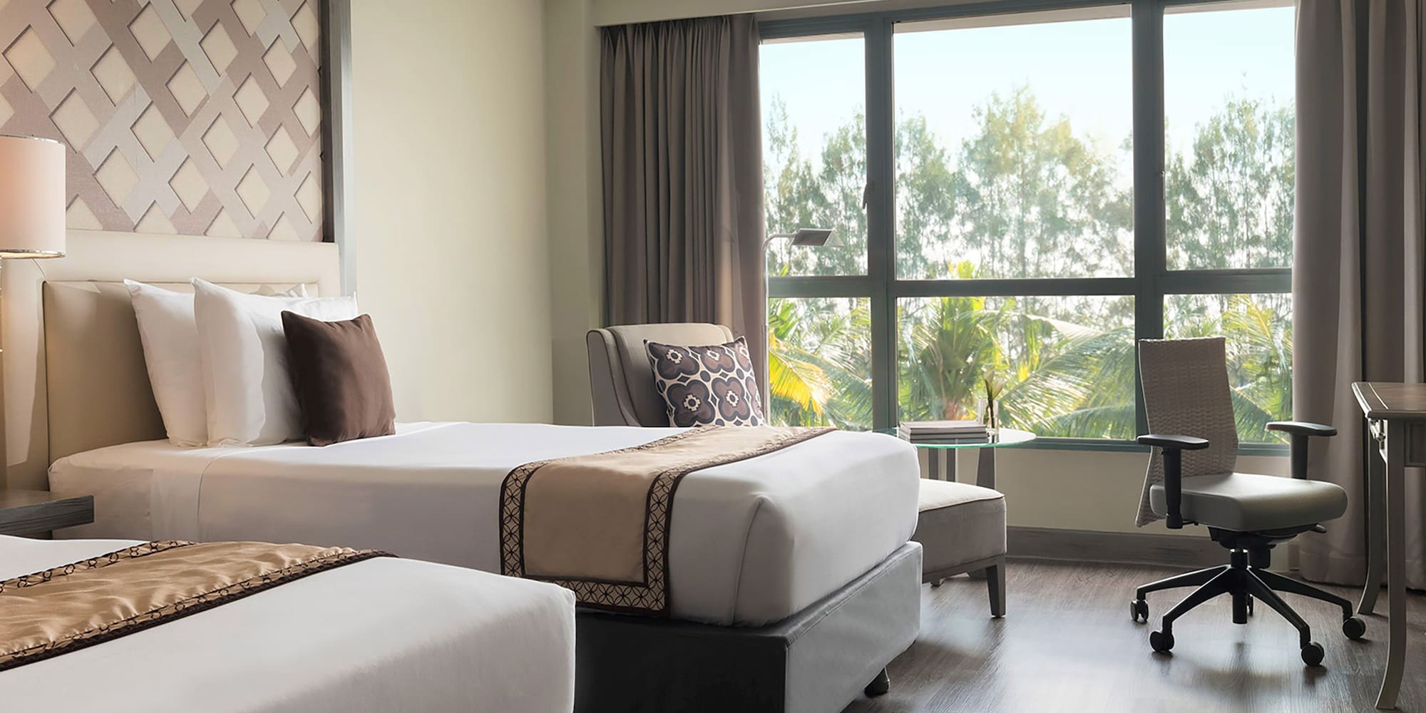 a room with two beds and a desk