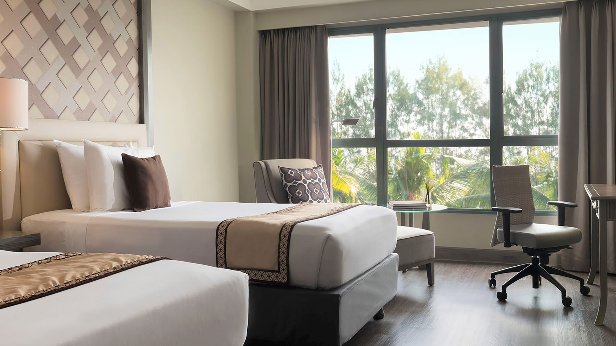 a room with two beds and a desk