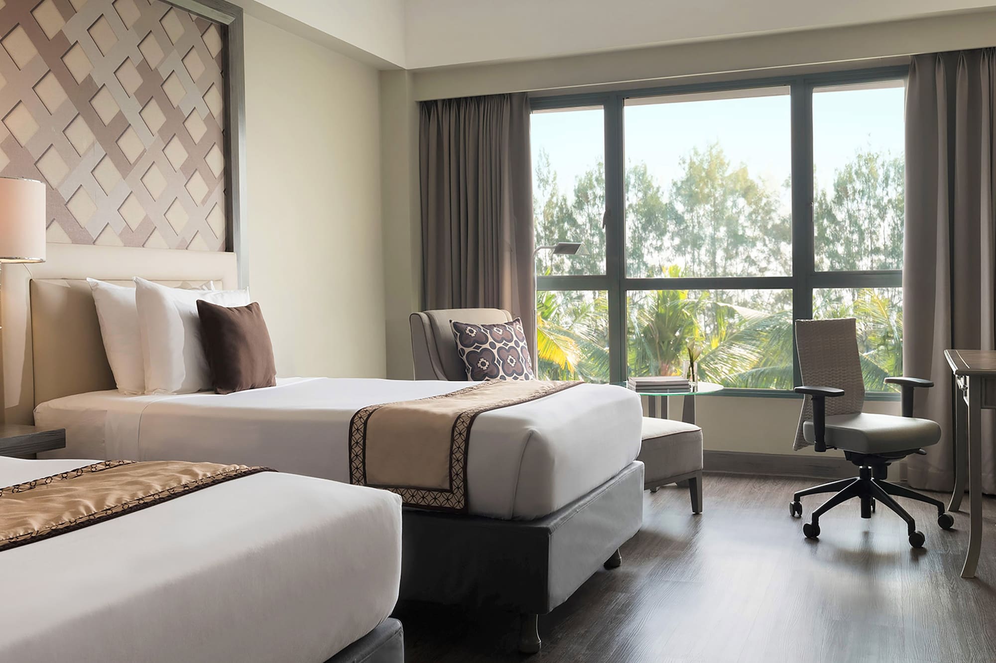 a room with two beds and a desk