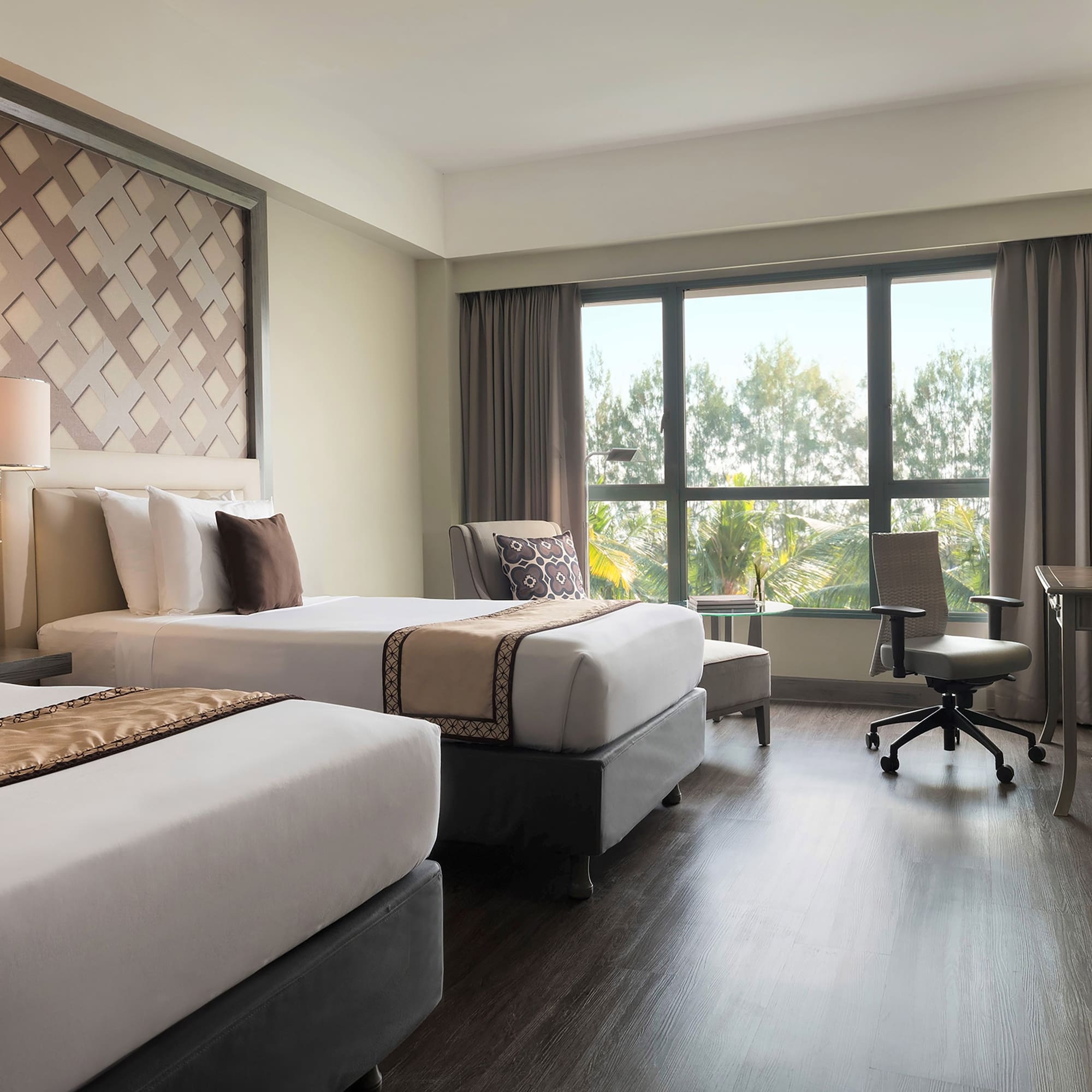 a room with two beds and a desk