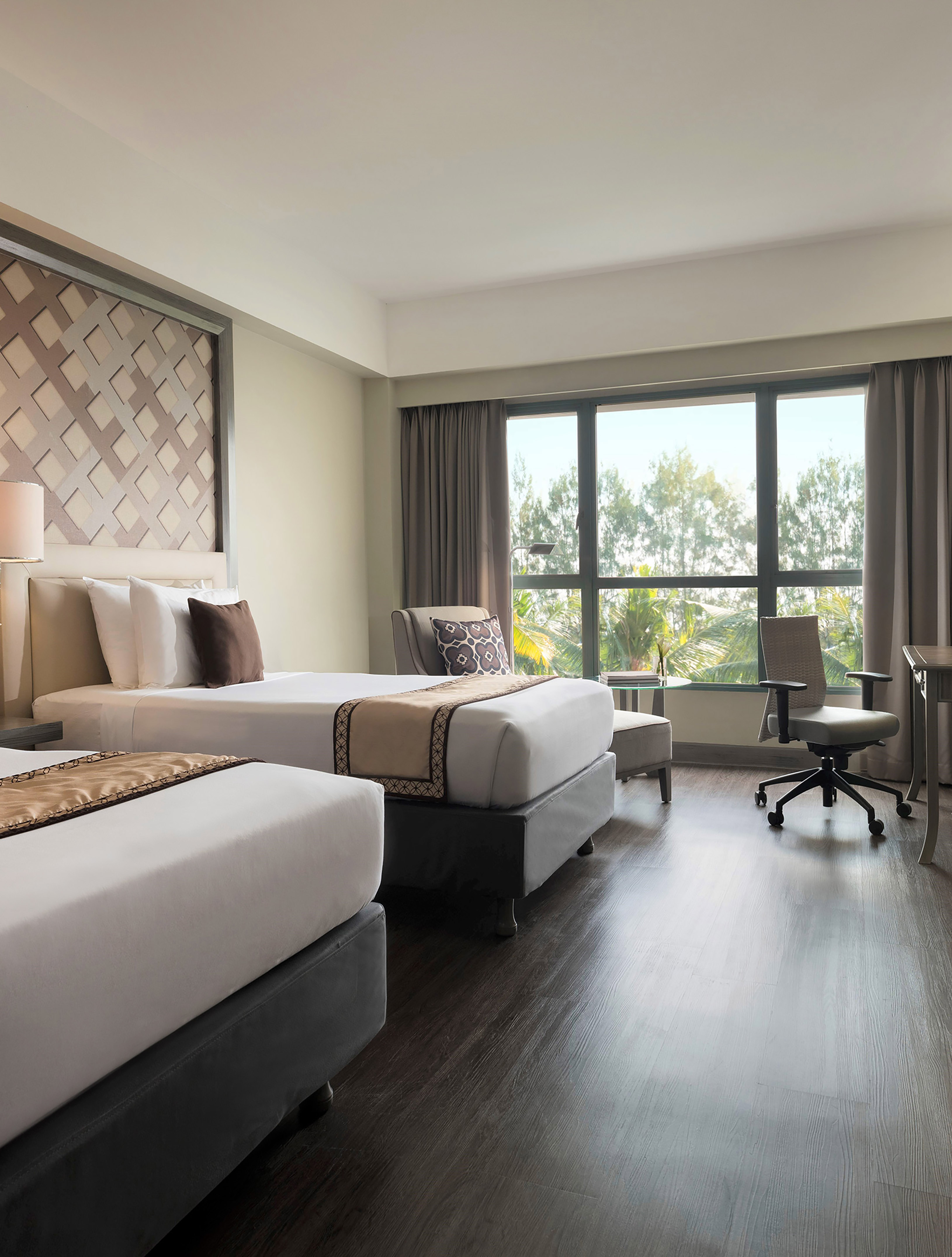a room with two beds and a desk