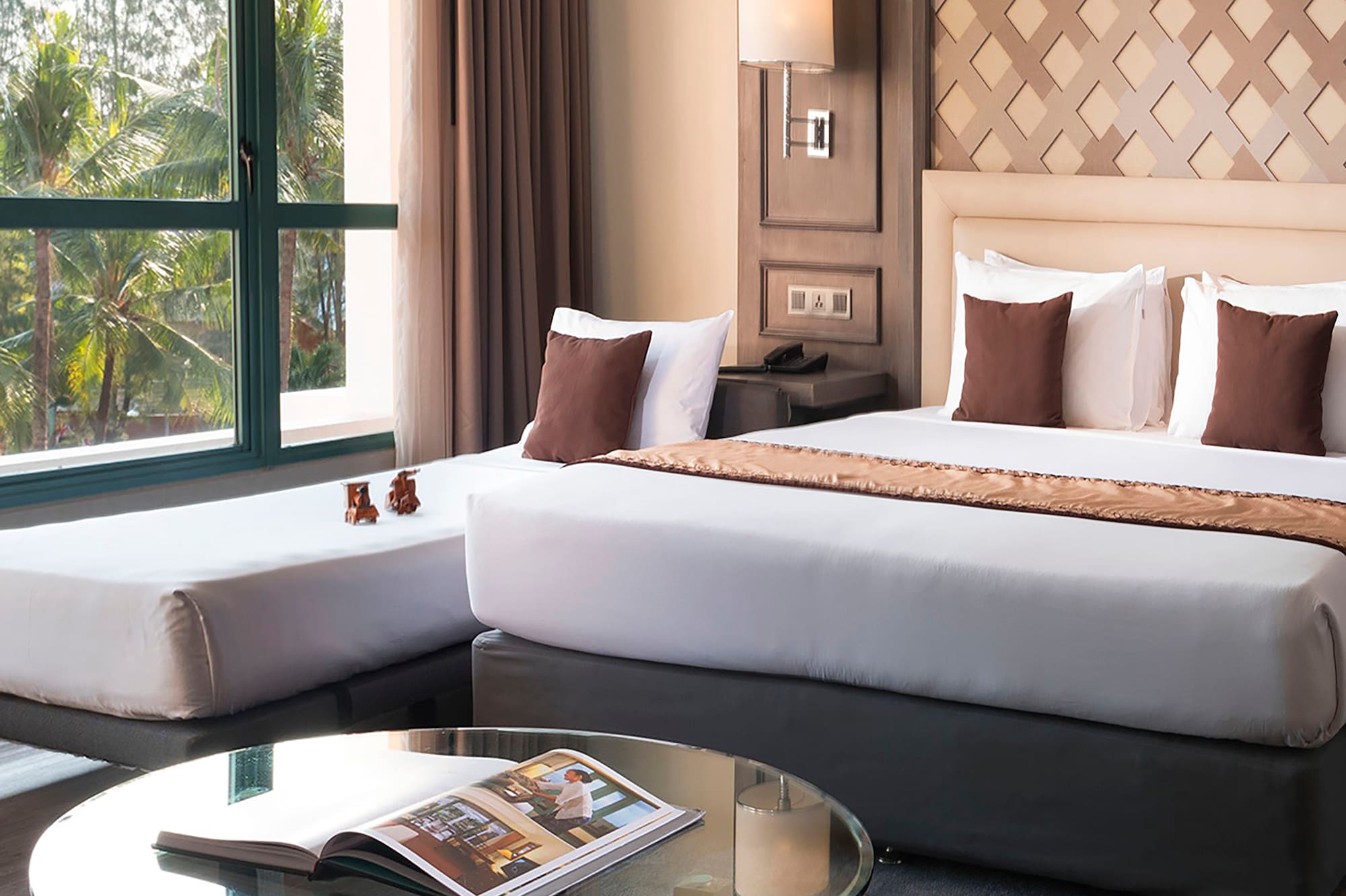 a room with two beds and a glass table