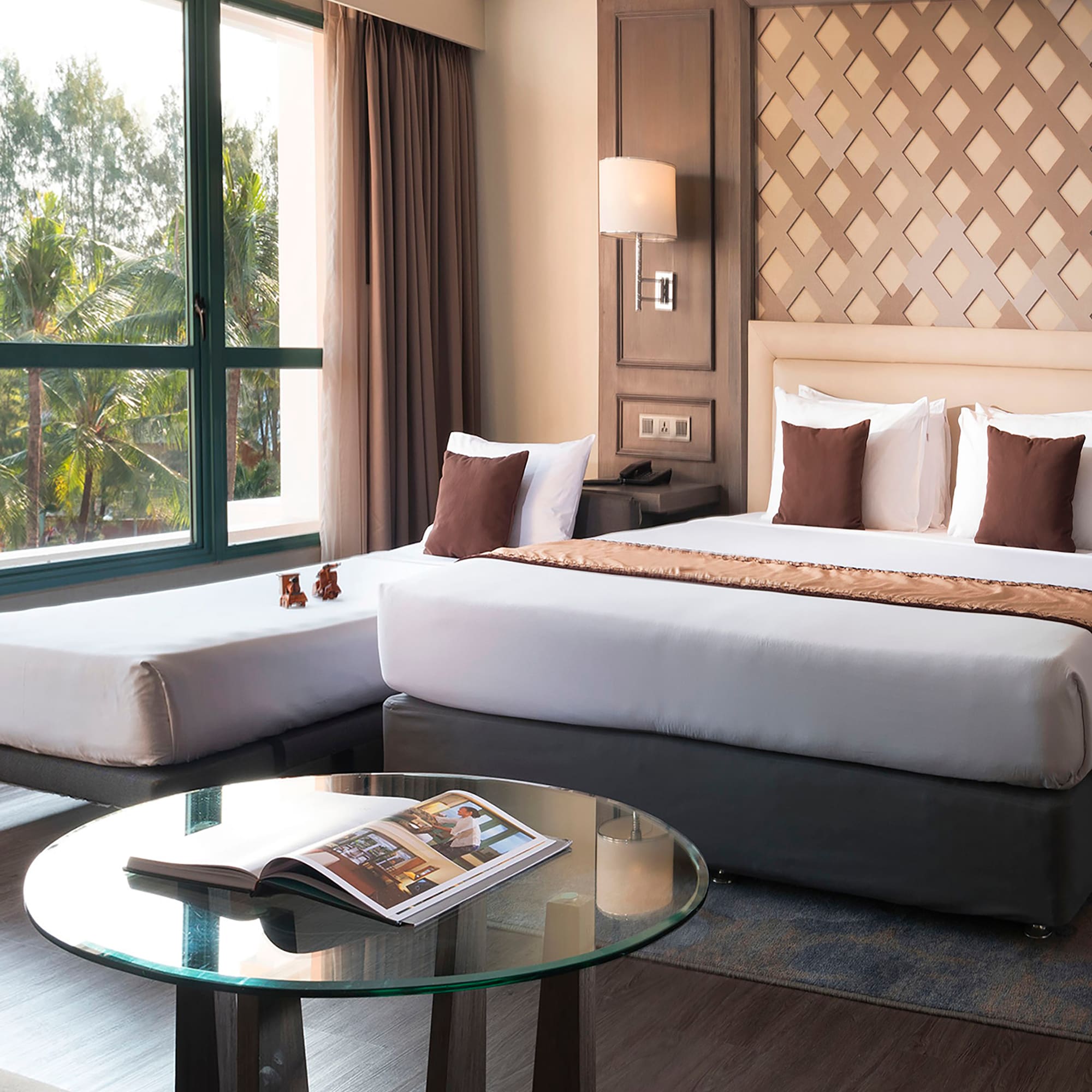 a room with two beds and a glass table