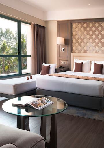 a room with two beds and a glass table