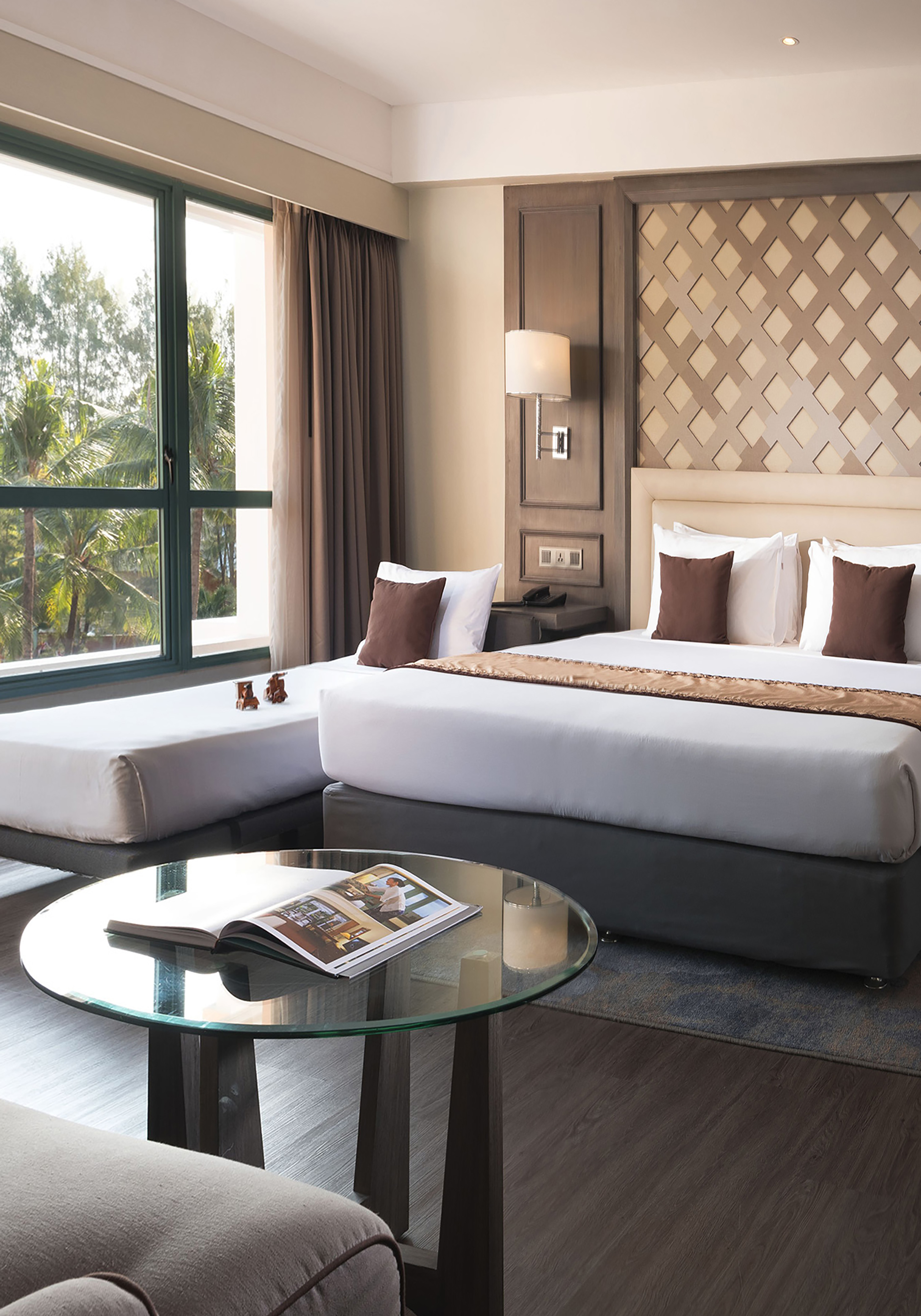 a room with two beds and a glass table