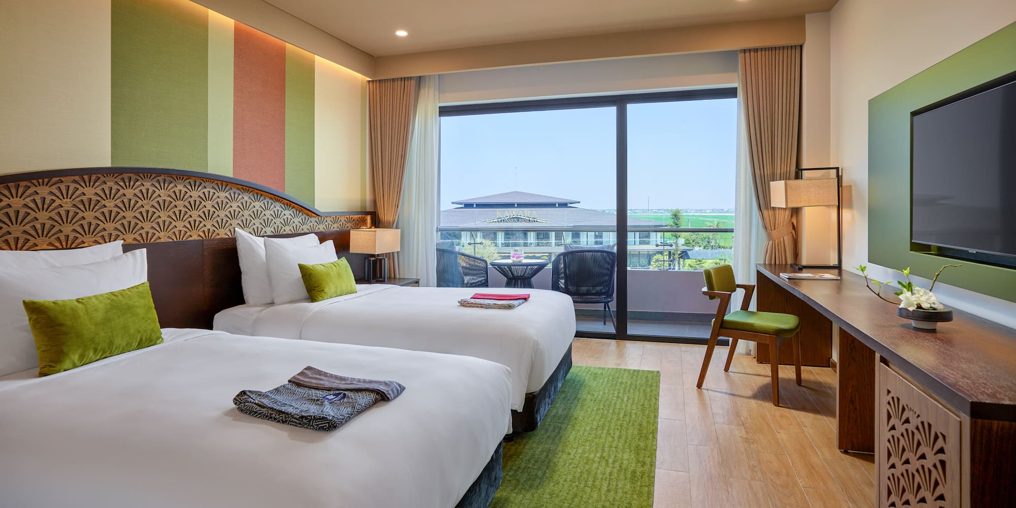 a room with two beds and a desk