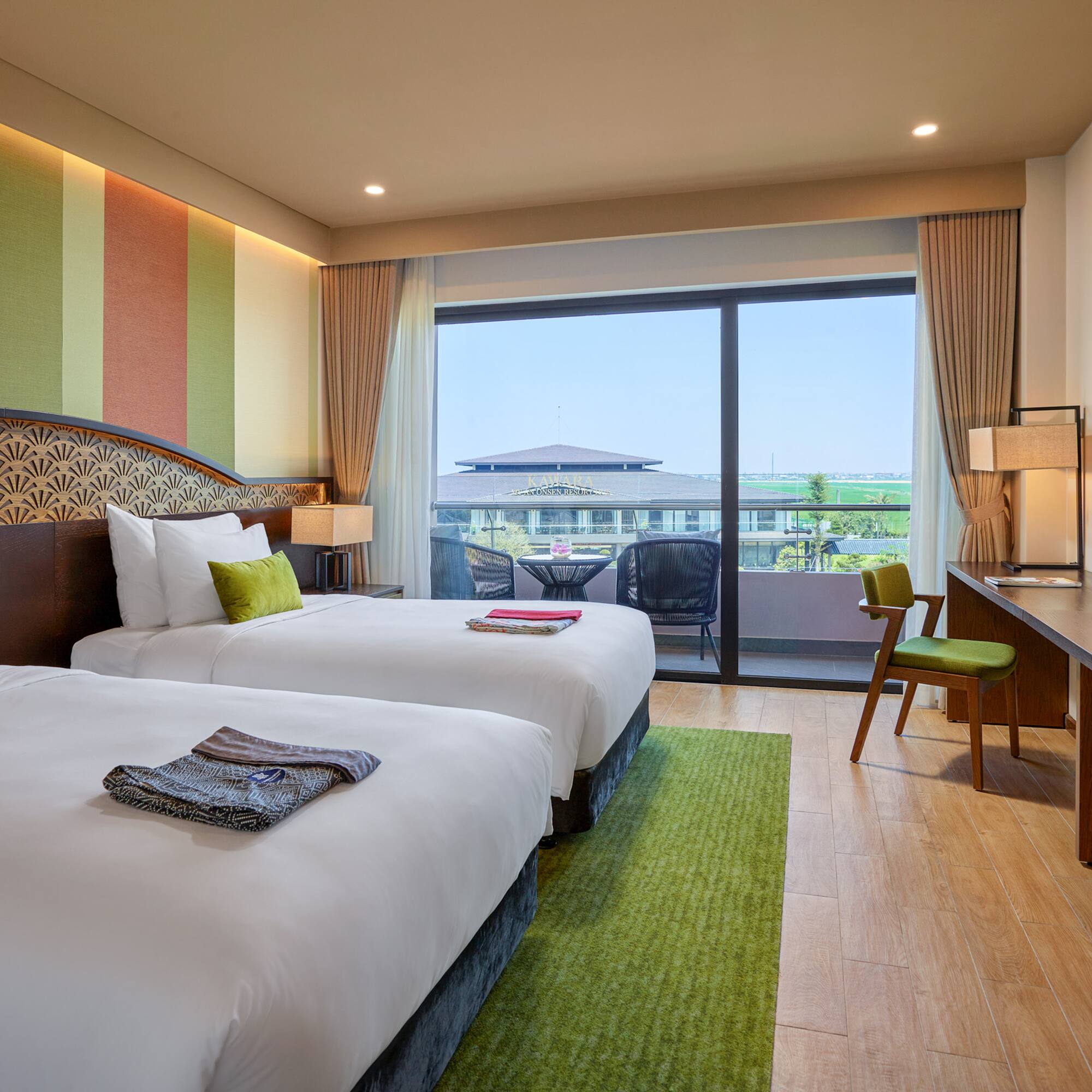 a room with two beds and a desk