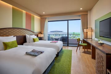 a room with two beds and a desk