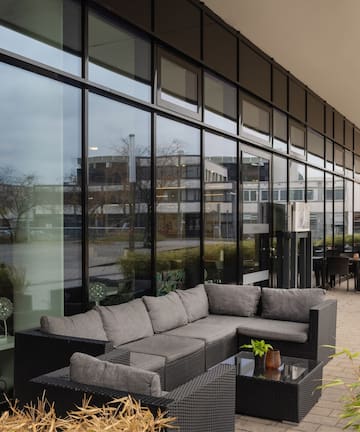 a couches and tables outside a building