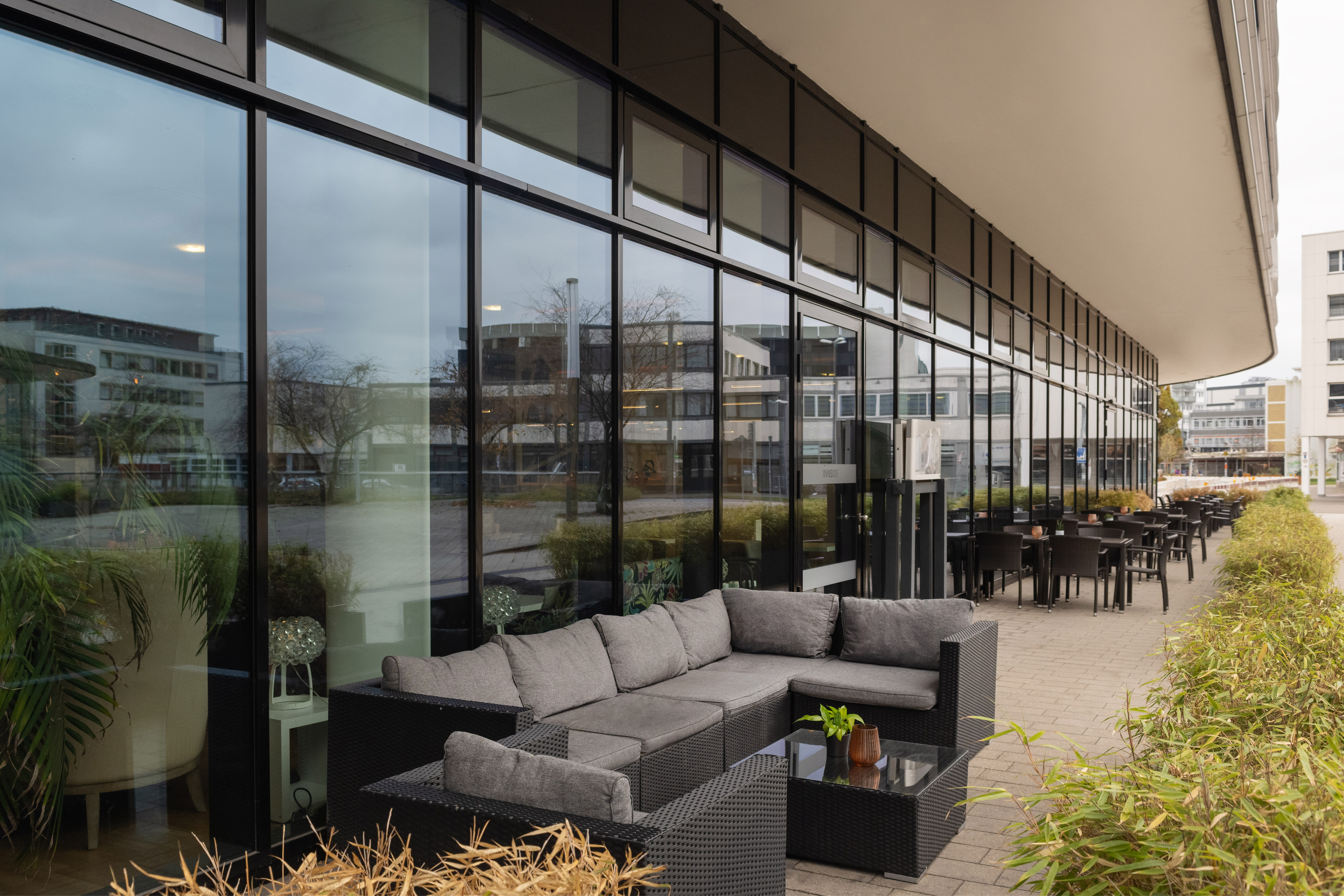 a couches and tables outside a building