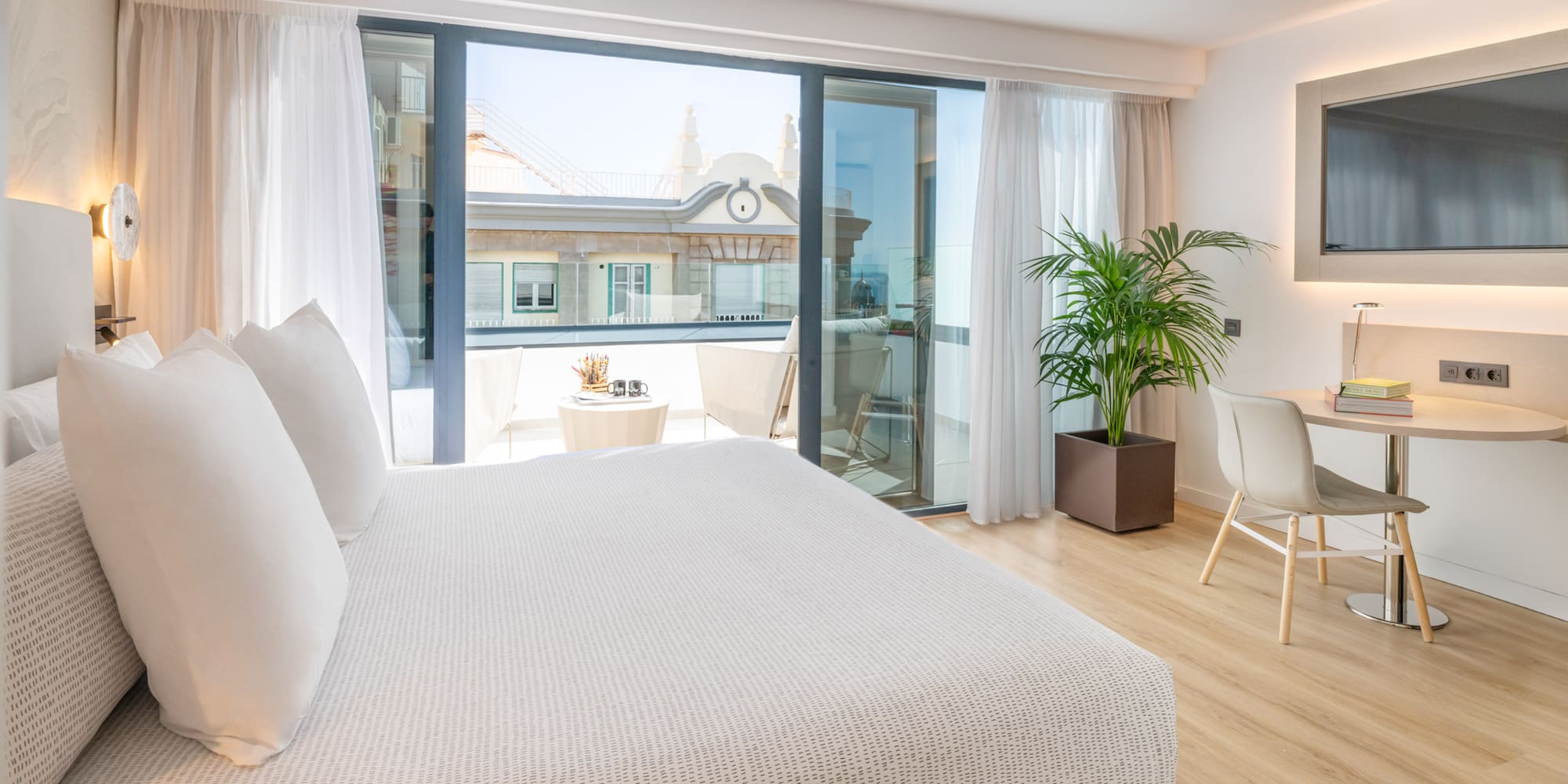 a bedroom with a bed and a table and chairs