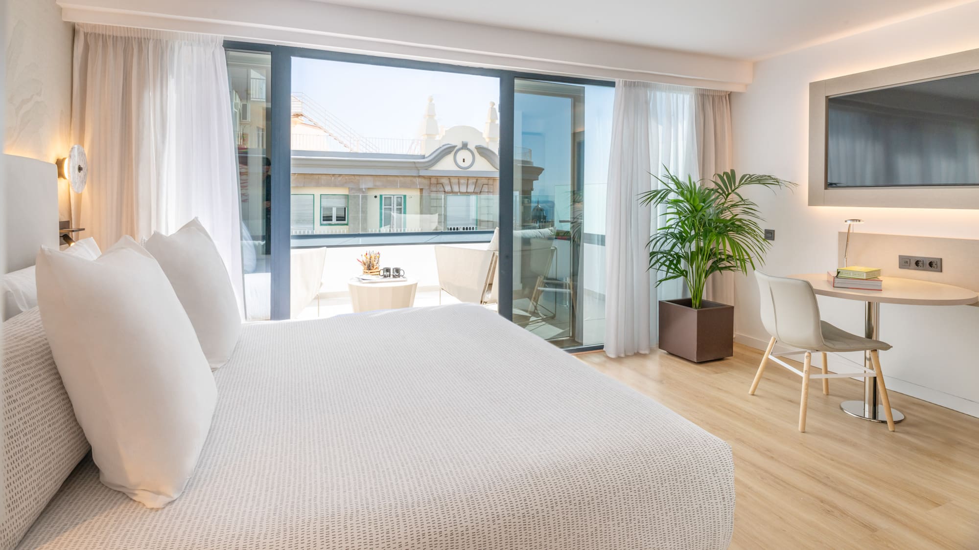 a bedroom with a bed and a table and chairs