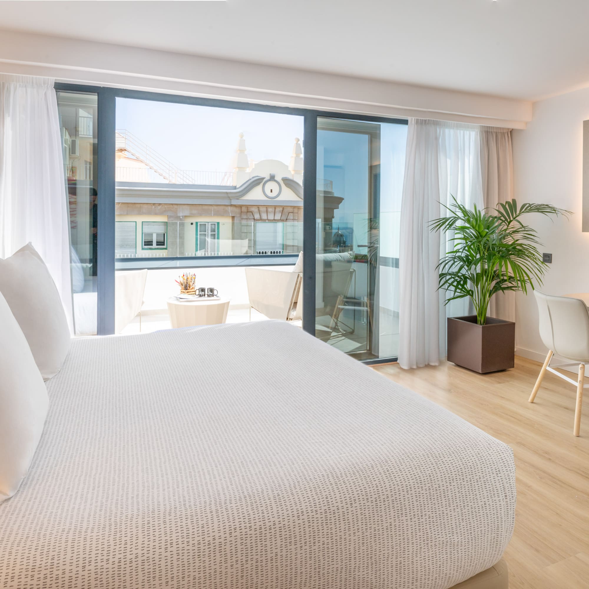 a bedroom with a bed and a table and chairs