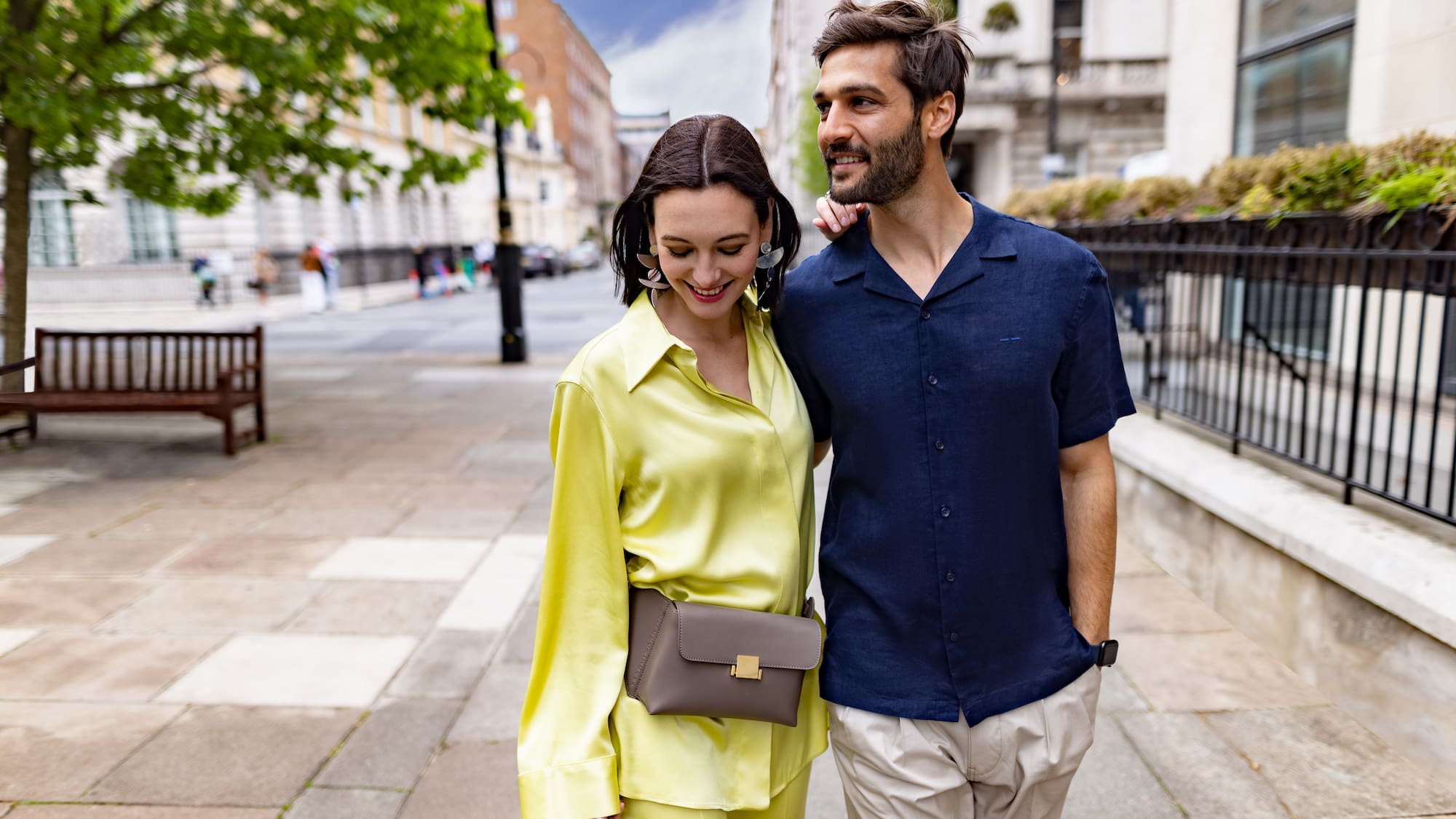 a man and woman walking down a sidewalk