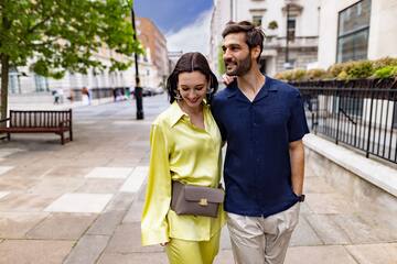 a man and woman walking down a sidewalk