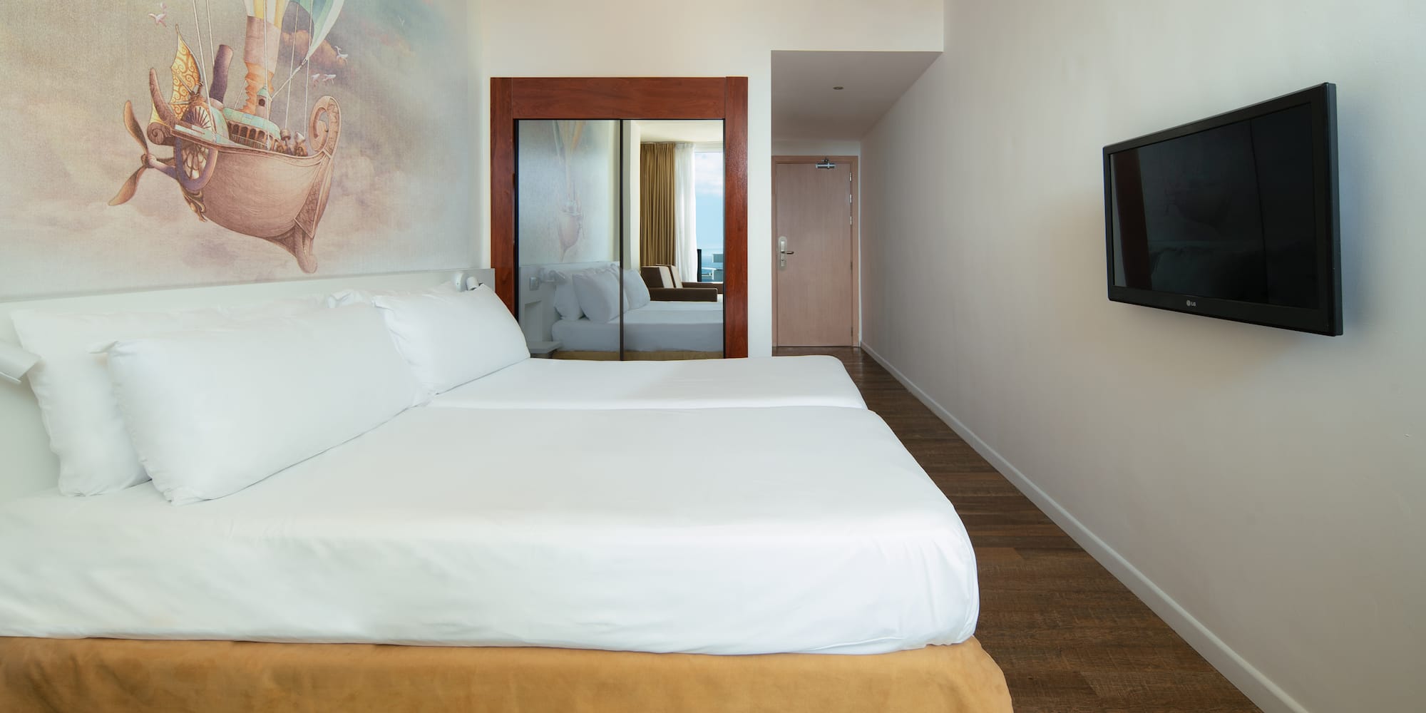 a room with a bed and a television