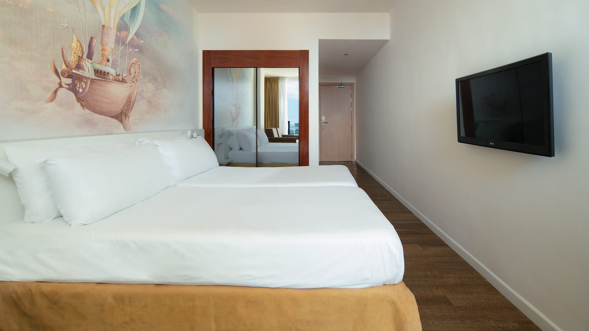 a room with a bed and a television