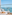 Balcony daybed with ocean view, distant island, straw hat, and glass railing.