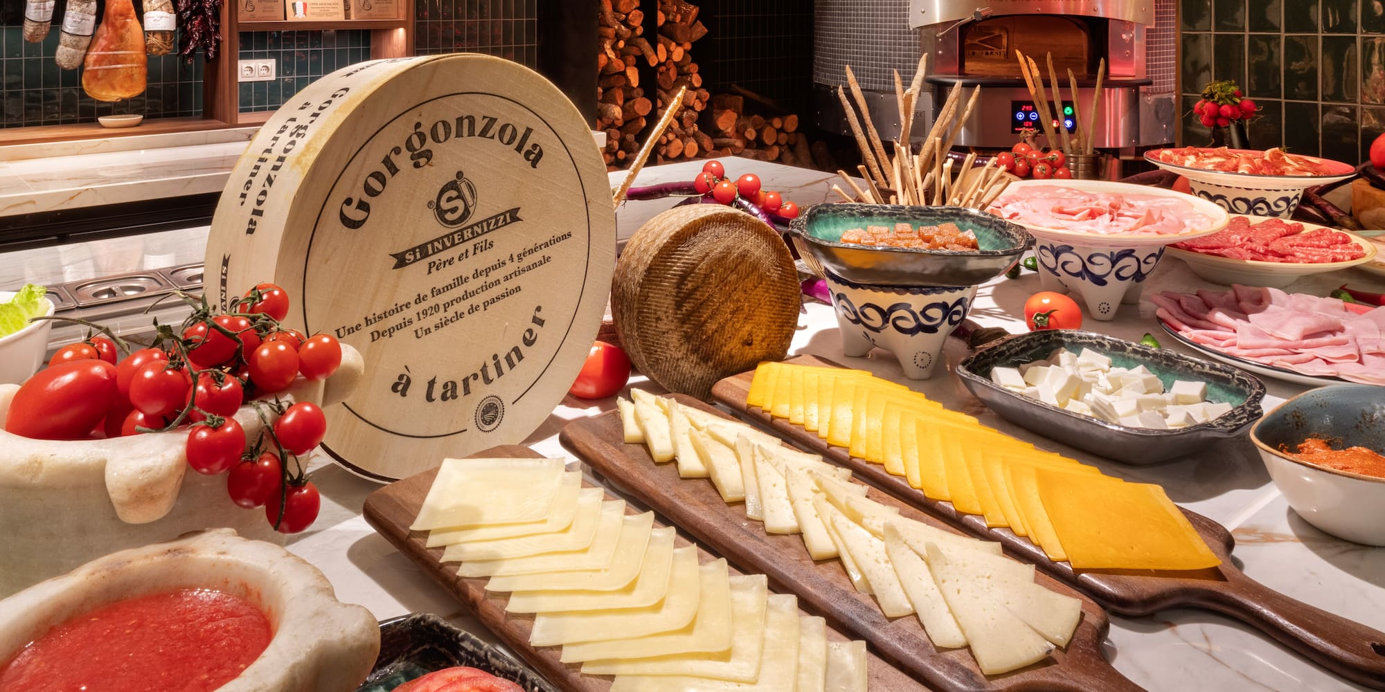 a table with different types of cheese and tomatoes