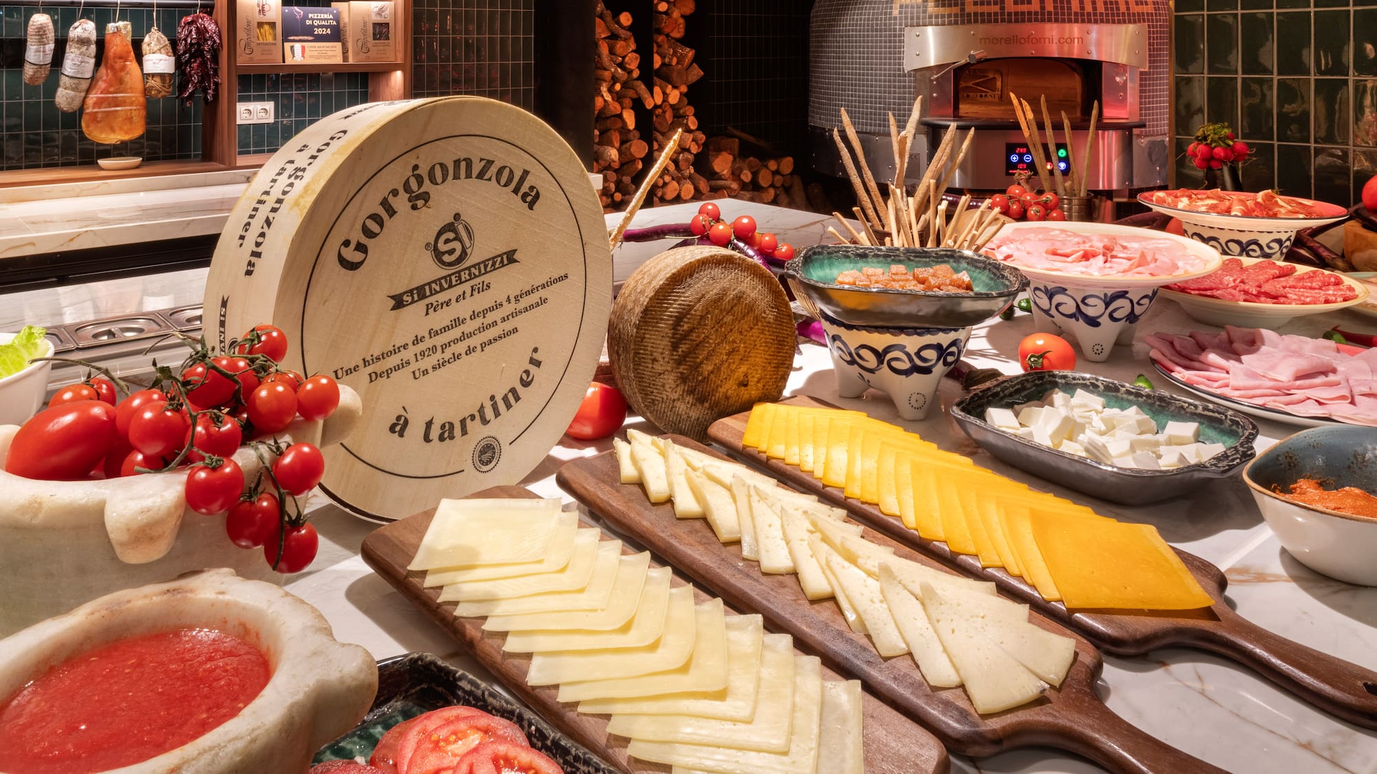 a table with different types of cheese and tomatoes