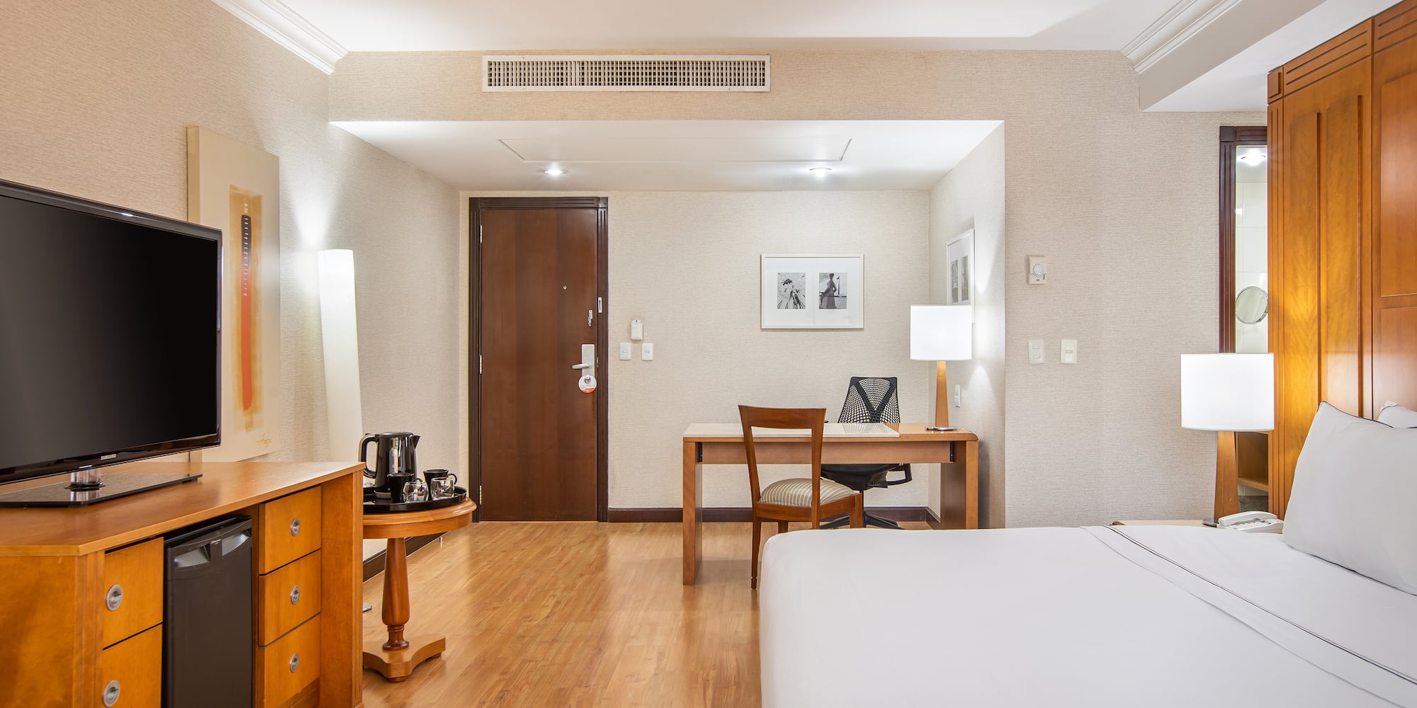 a room with a bed and desk and a chair