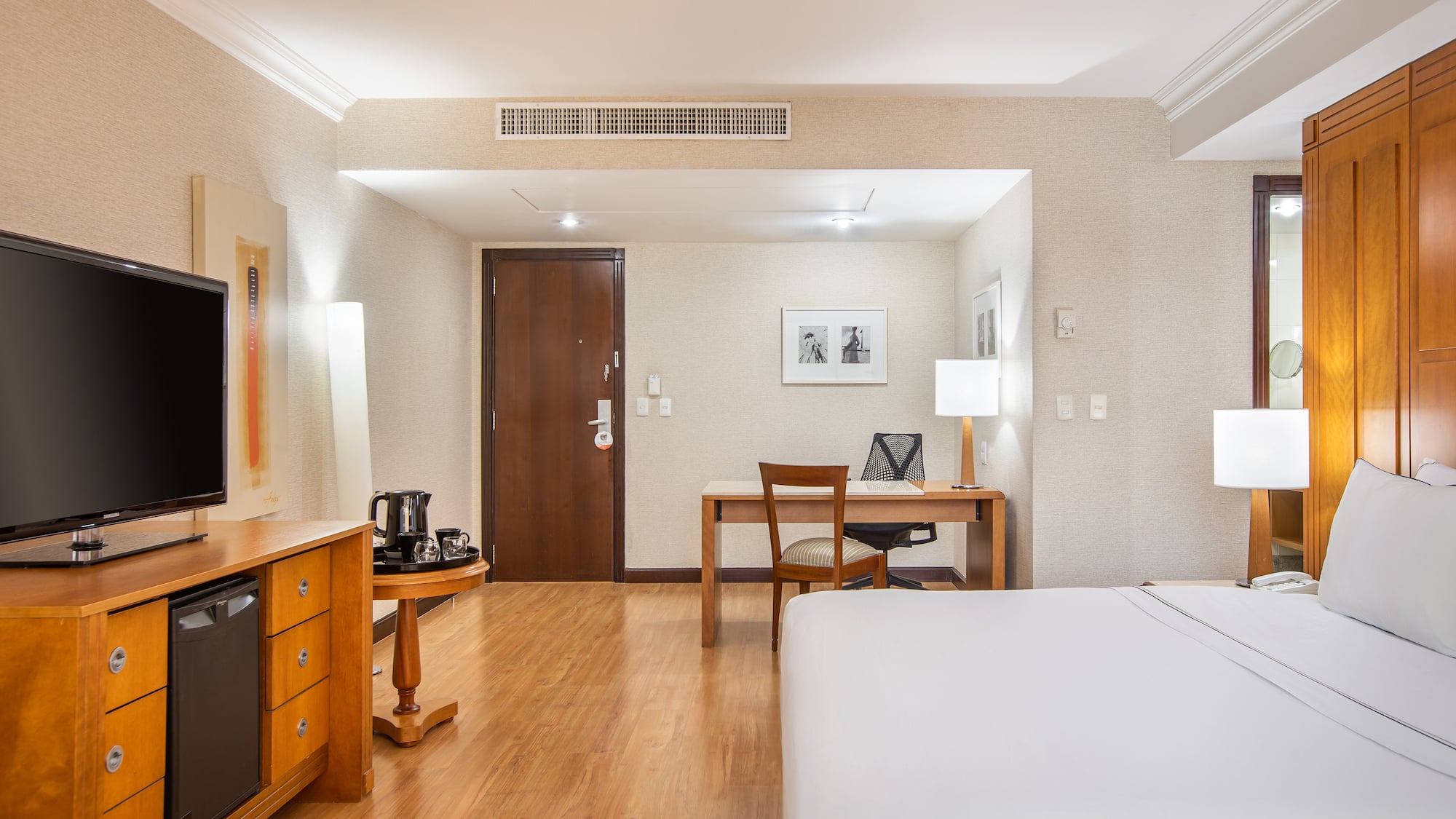 a room with a bed and desk and a chair