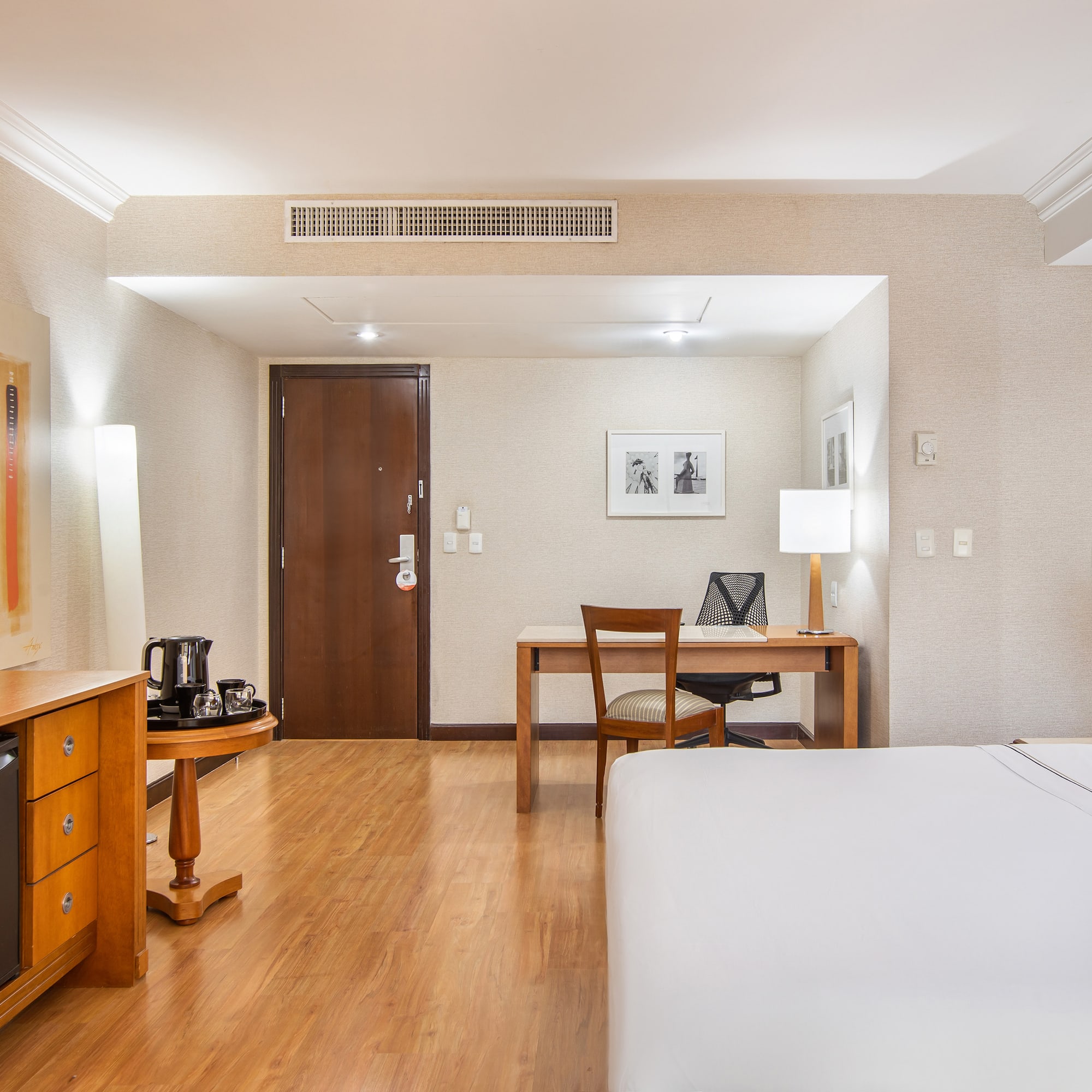 a room with a bed and desk and a chair