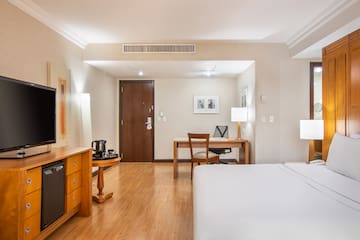 a room with a bed and desk and a chair