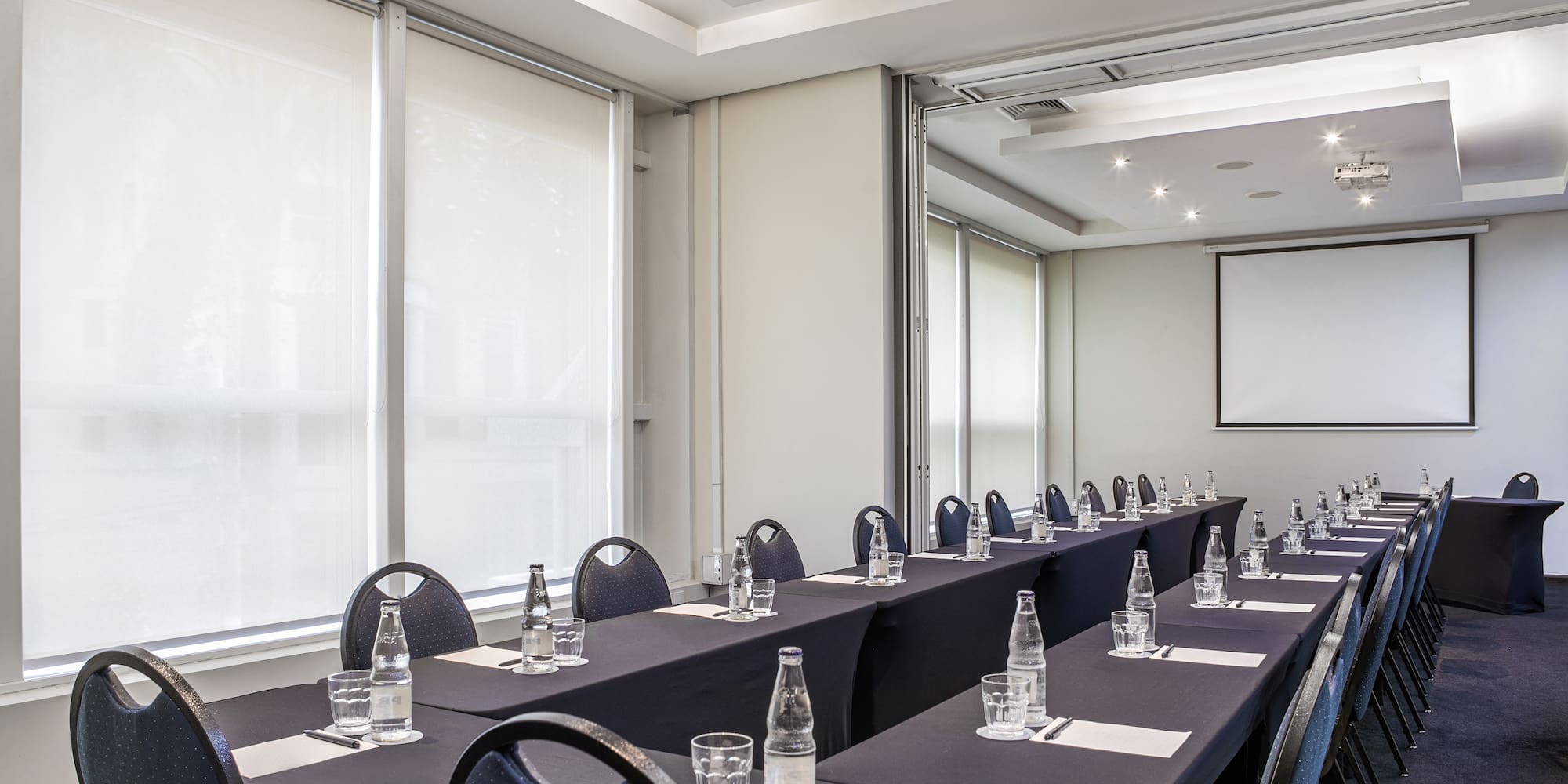 a room with long tables and chairs