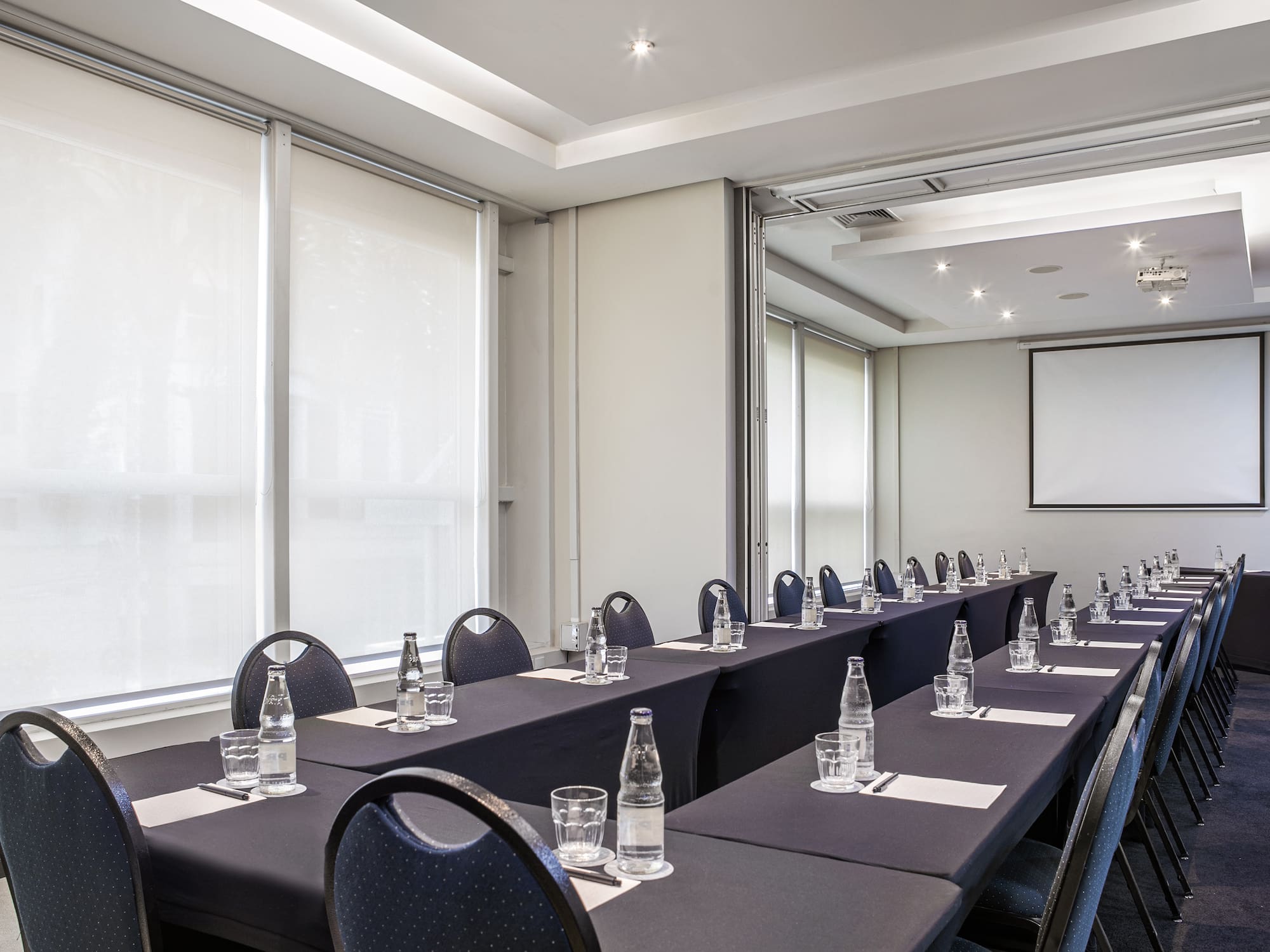 a room with long tables and chairs