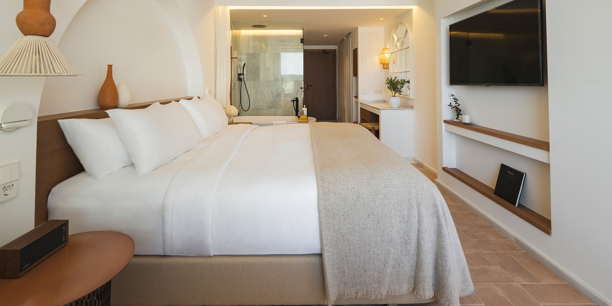 a bedroom with a large bed and a television