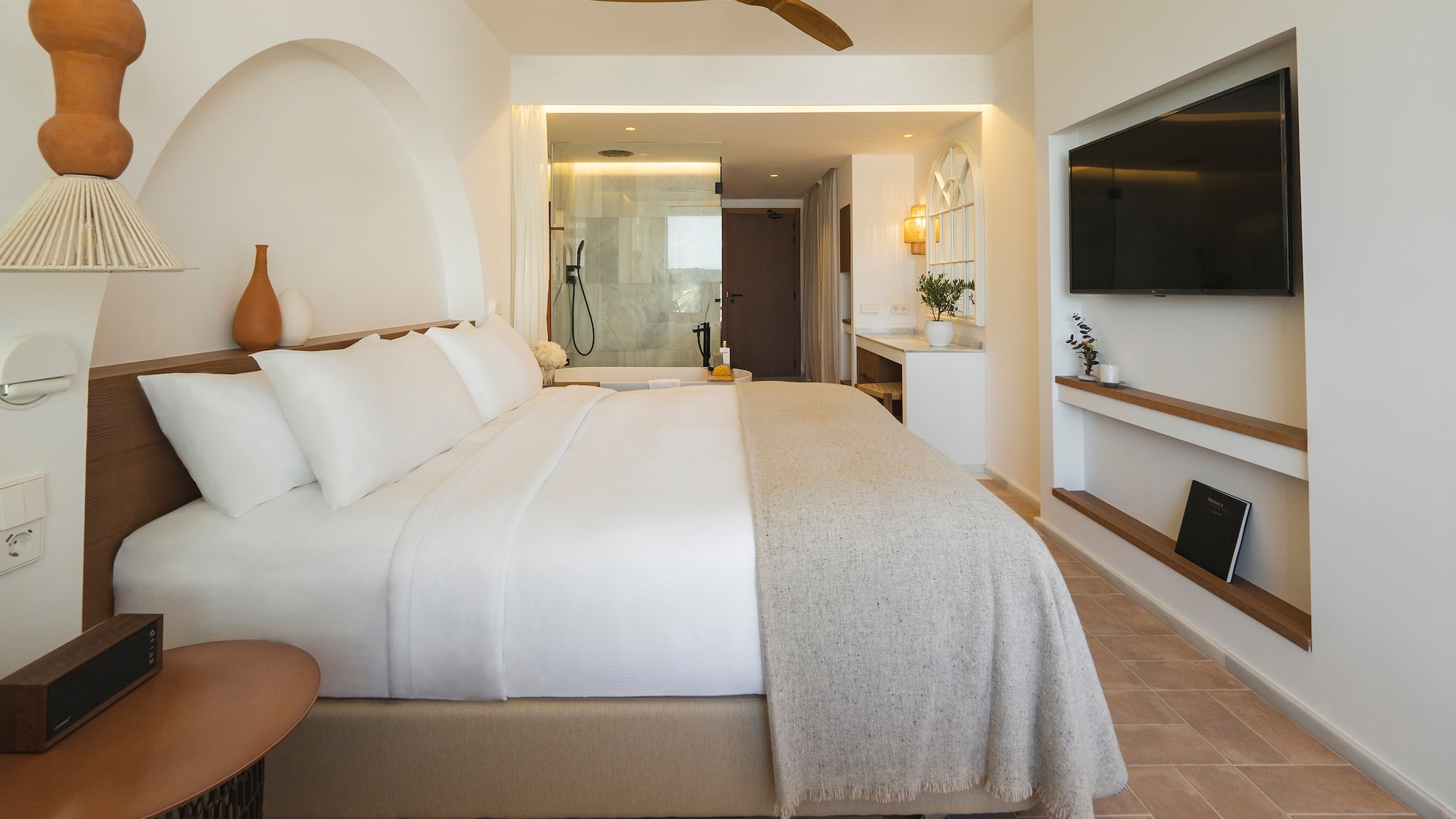 a bedroom with a large bed and a television