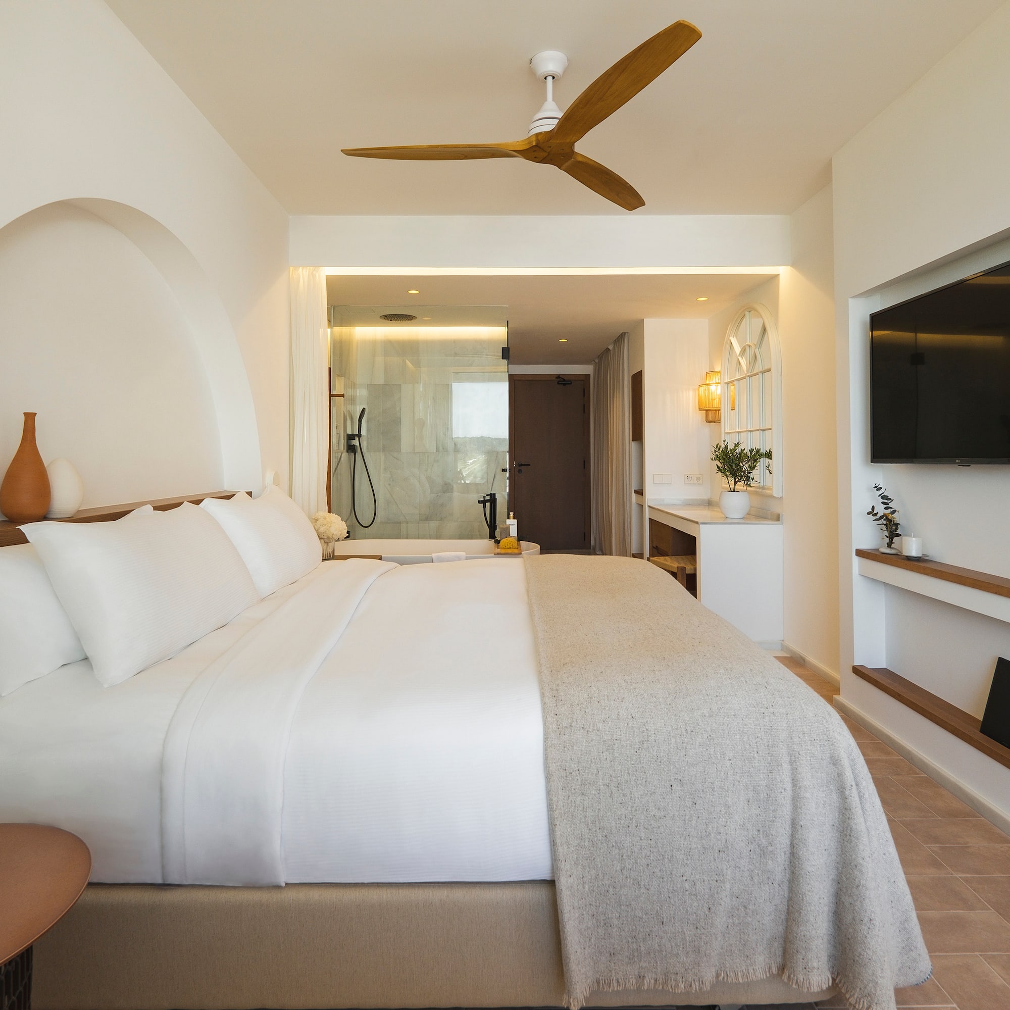 a bedroom with a large bed and a television