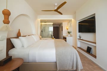 a bedroom with a large bed and a television