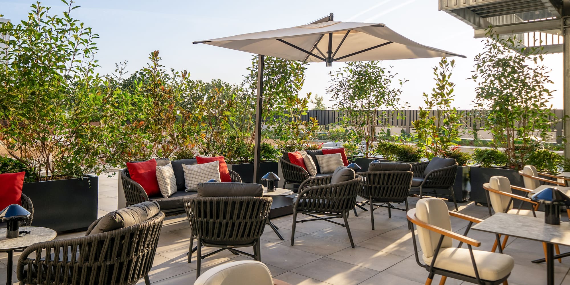 a patio with chairs and umbrellas