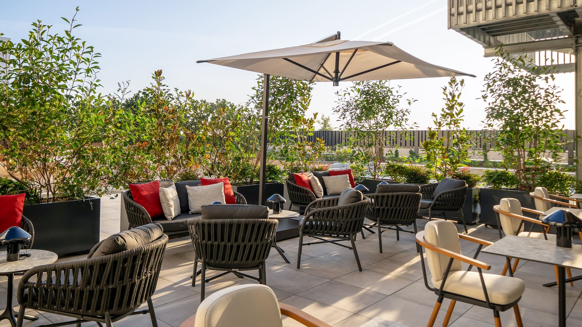 a patio with chairs and umbrellas