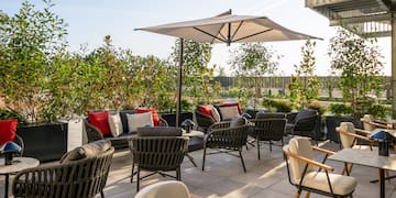 a patio with chairs and umbrellas