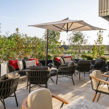 a patio with chairs and umbrellas