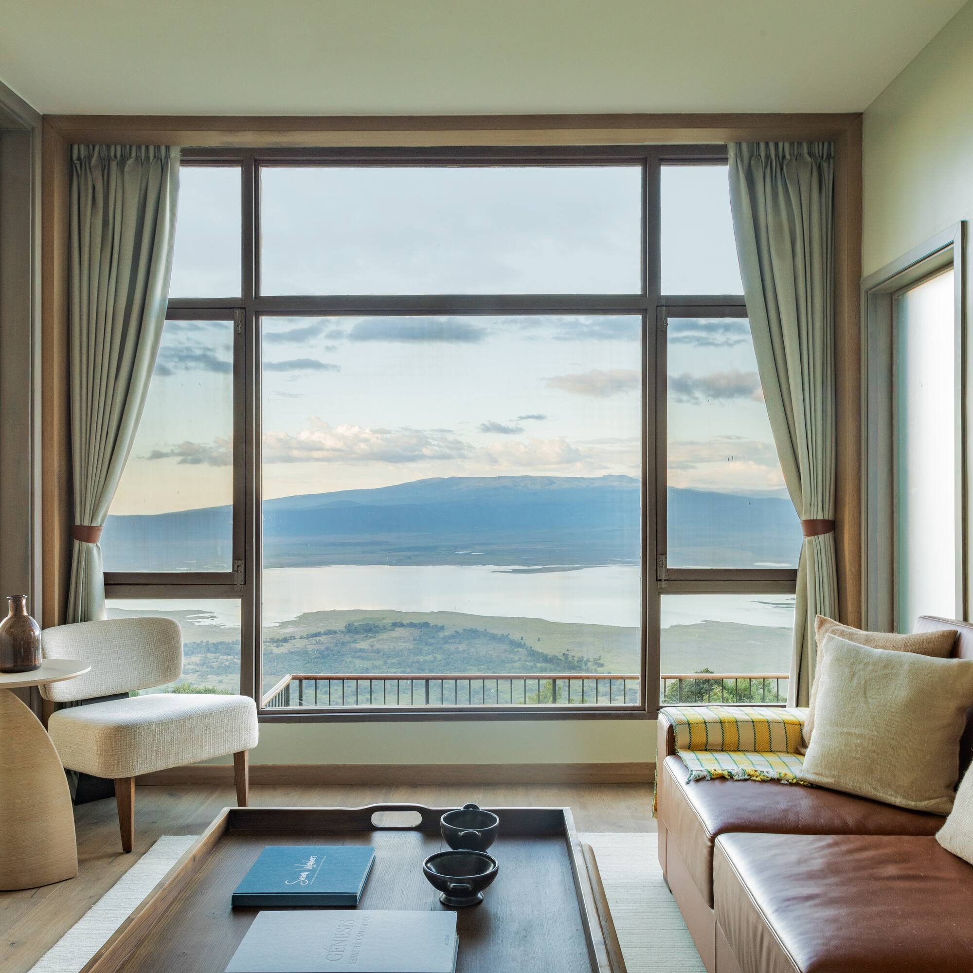 a living room with a view of a lake and mountains