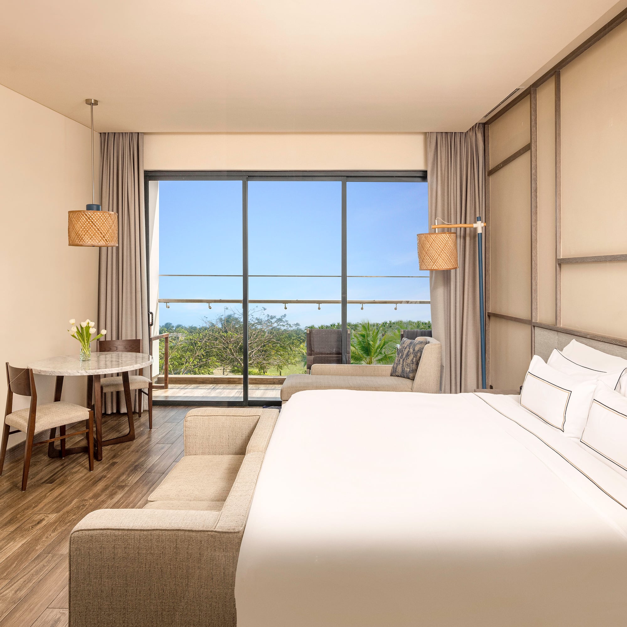 a room with a bed and a table and chairs