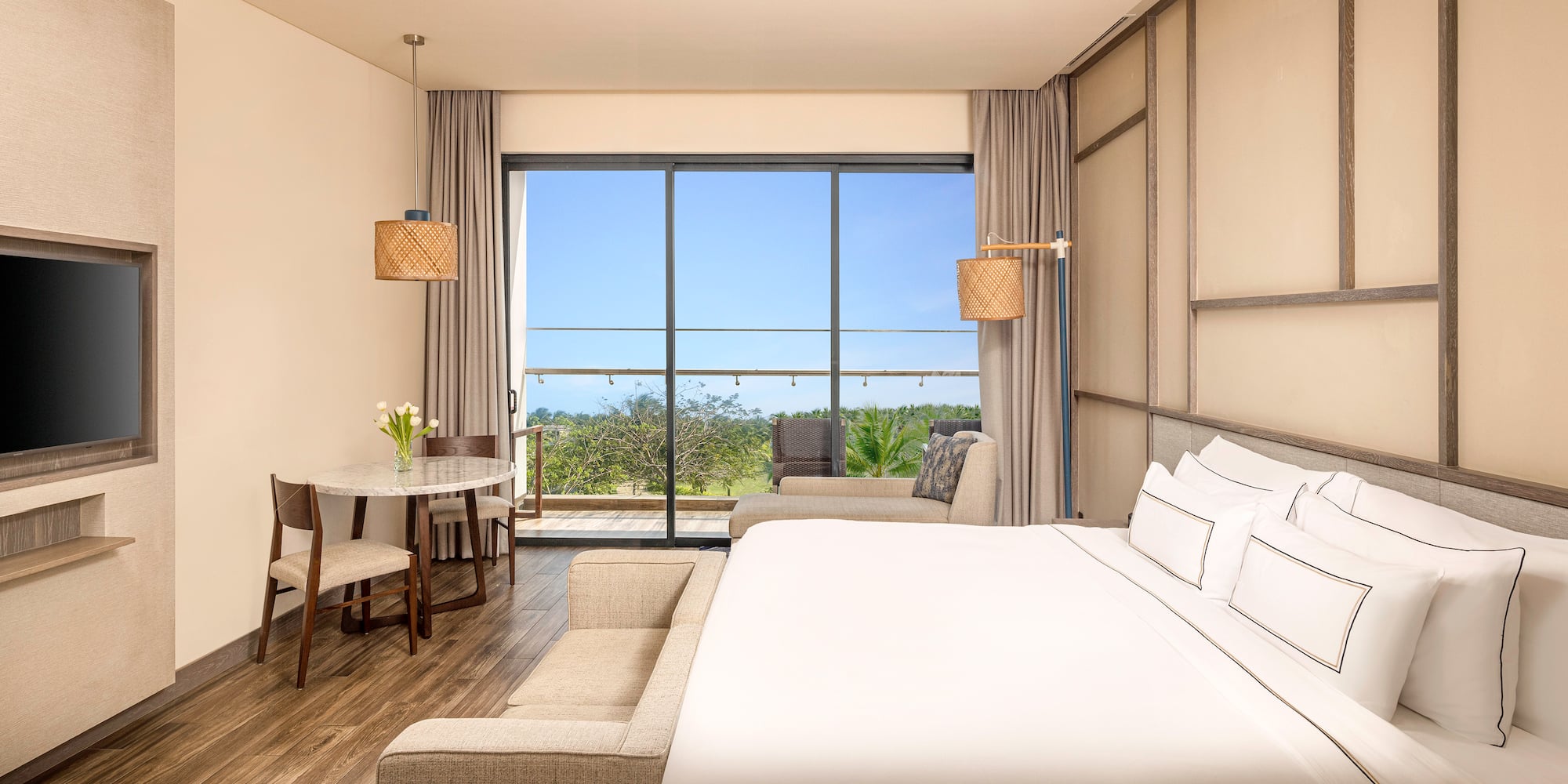 a room with a bed and a table and chairs