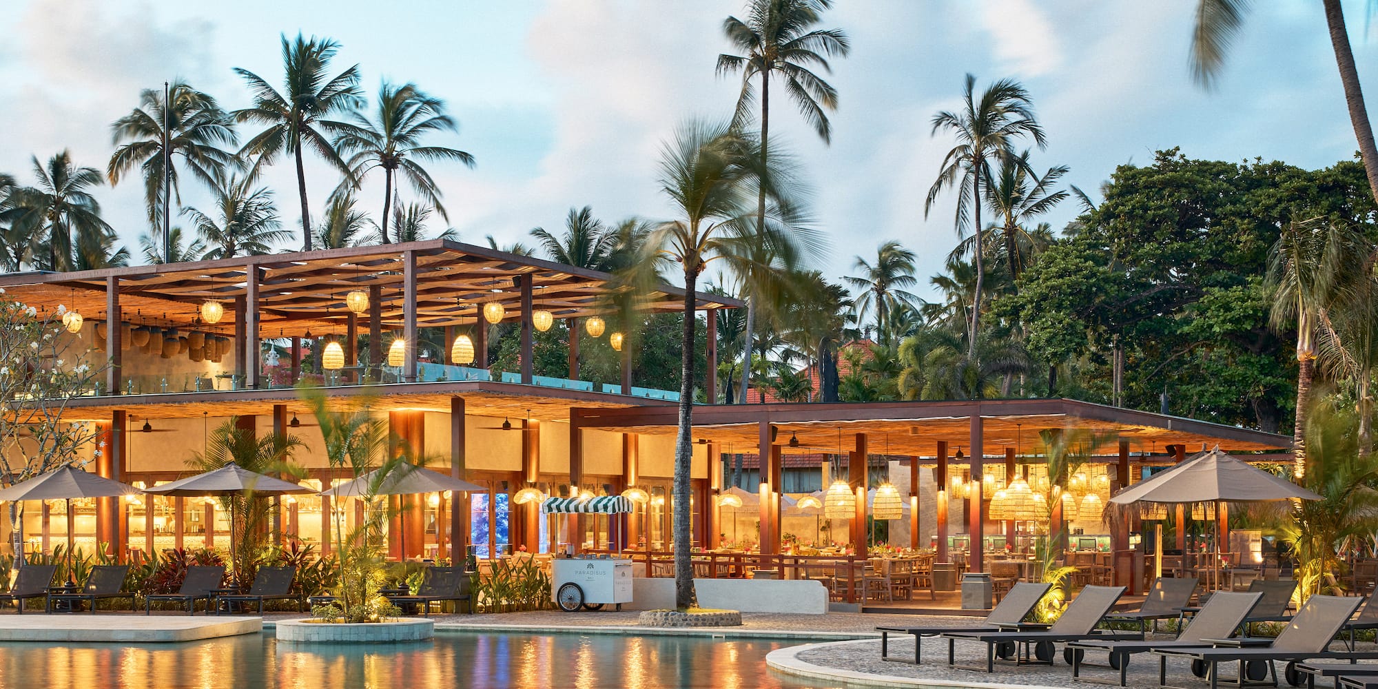 a pool with a building and palm trees