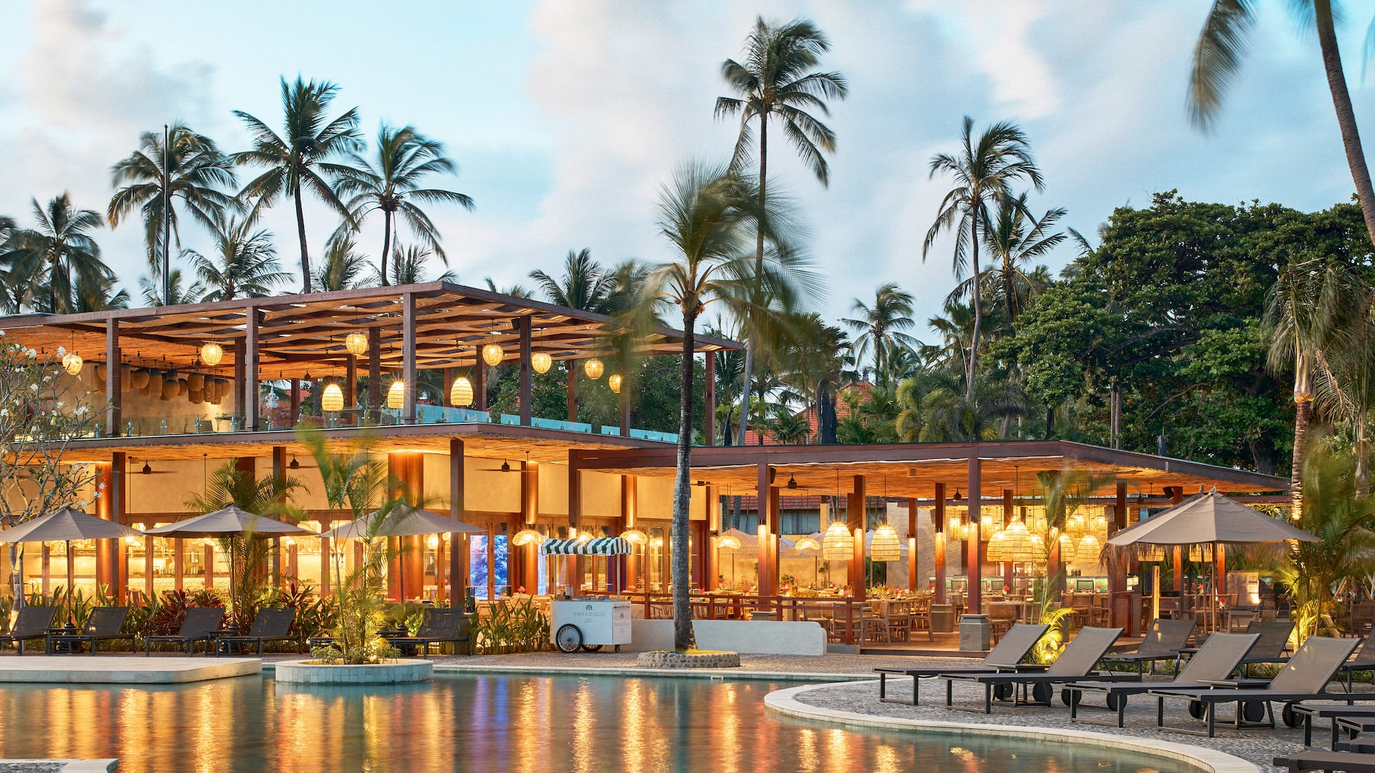 a pool with a building and palm trees