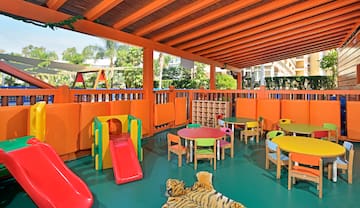 a play area with a slide and tables