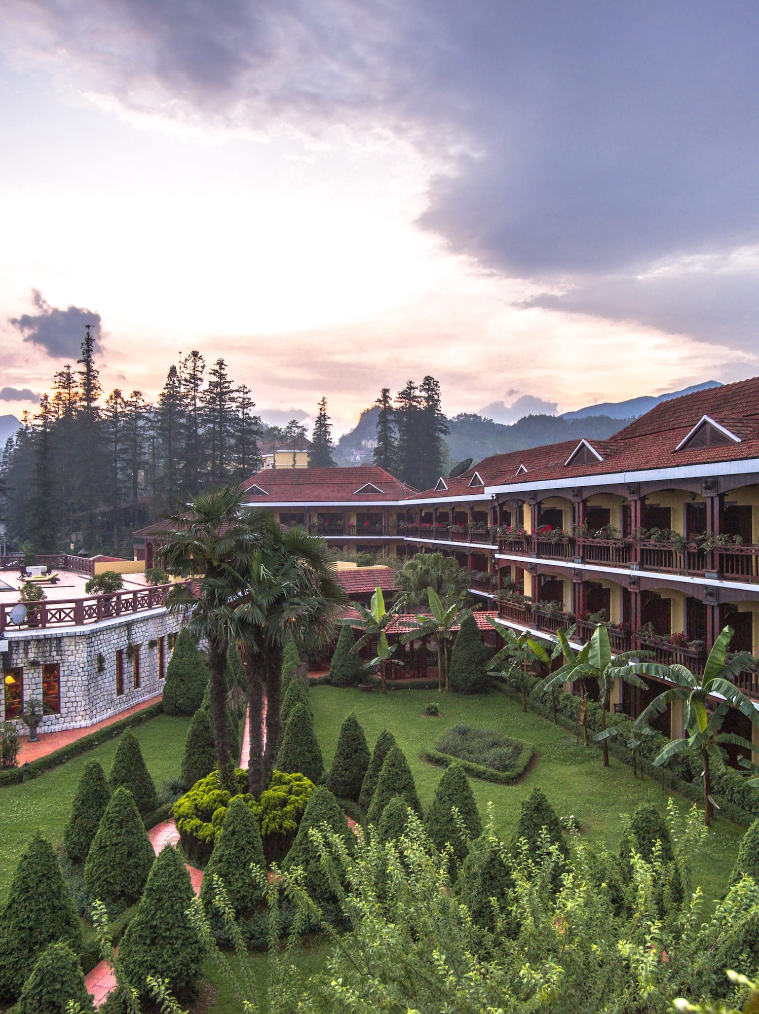 a building with trees and bushes in front of it