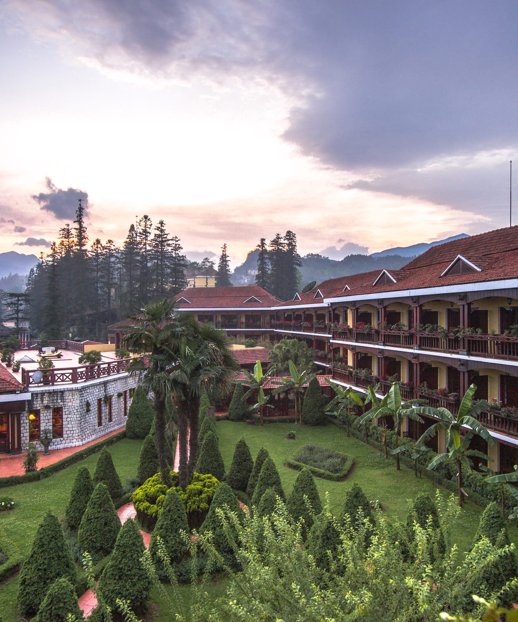 a building with trees and bushes in front of it