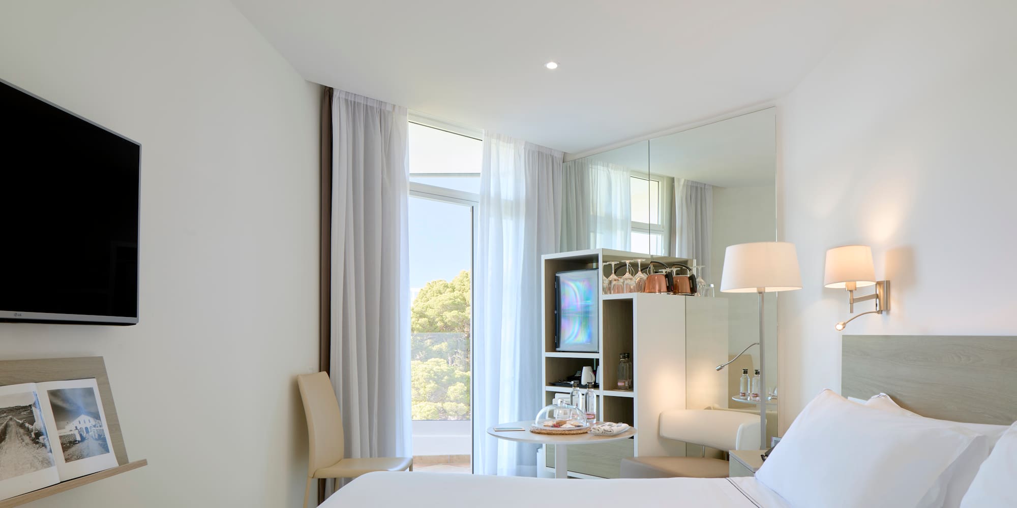 a room with a bed and a mirror